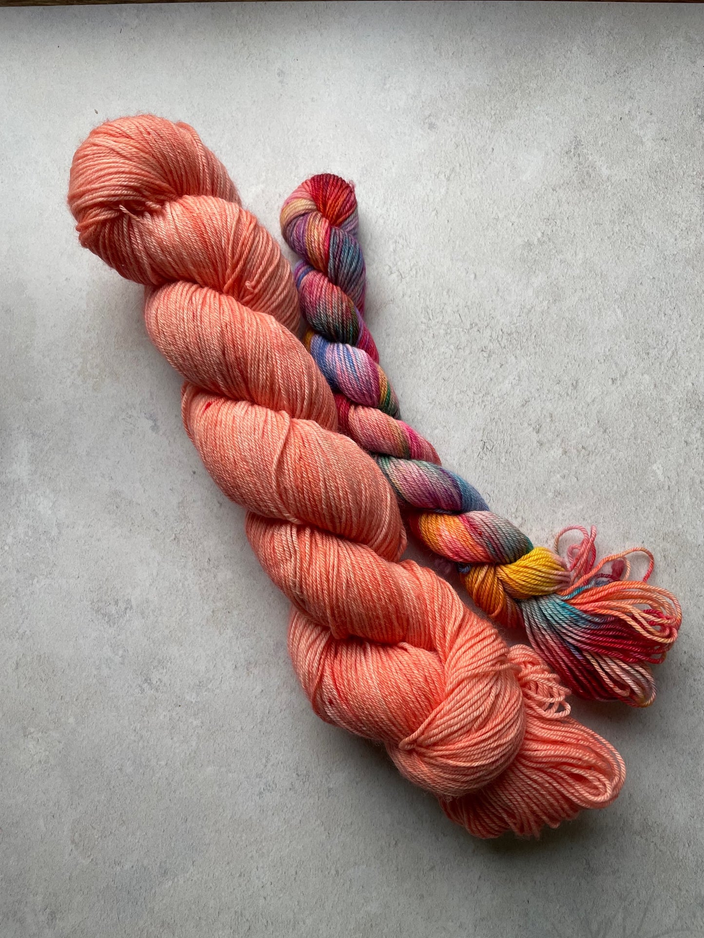 120g sock set with coral main skein and multicoloured mini skein