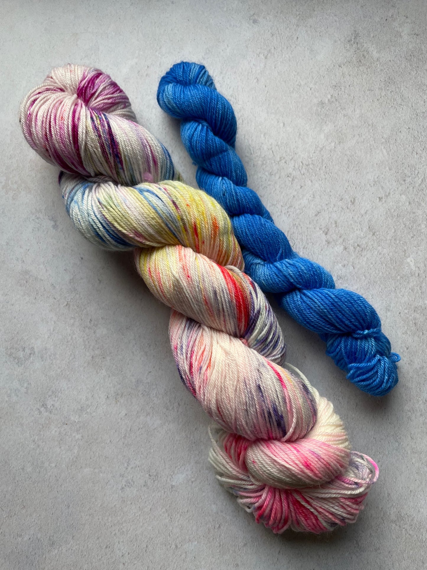 120g sock set with multicoloured main skein and blue mini skein