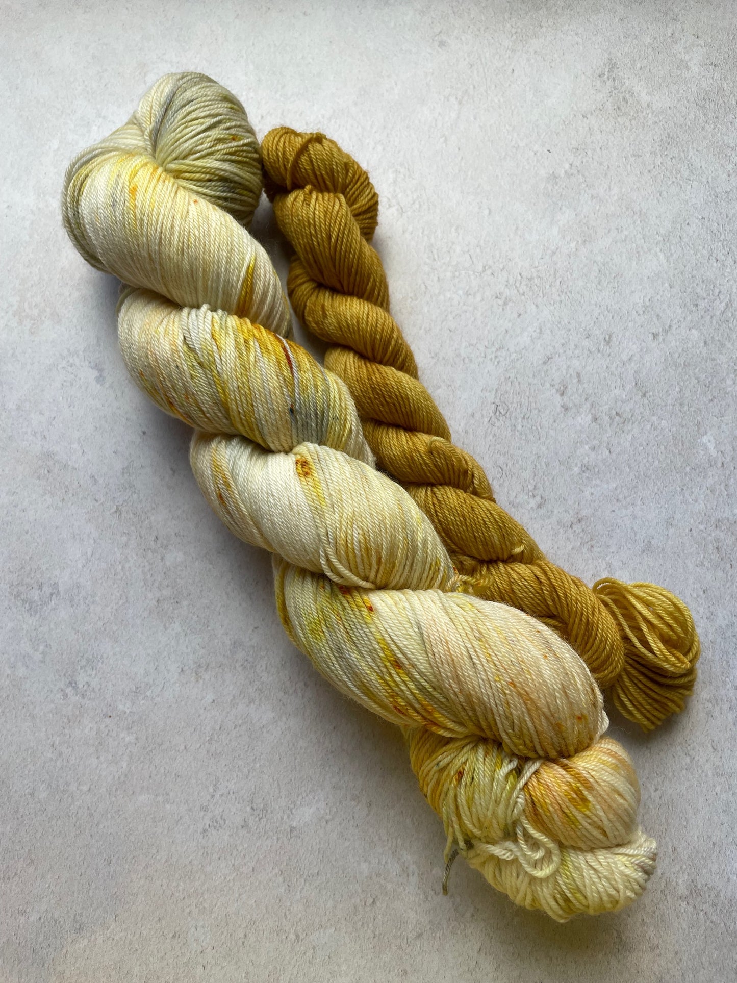 120g sock set with gold and yellow speckled main skein and gold mini skein