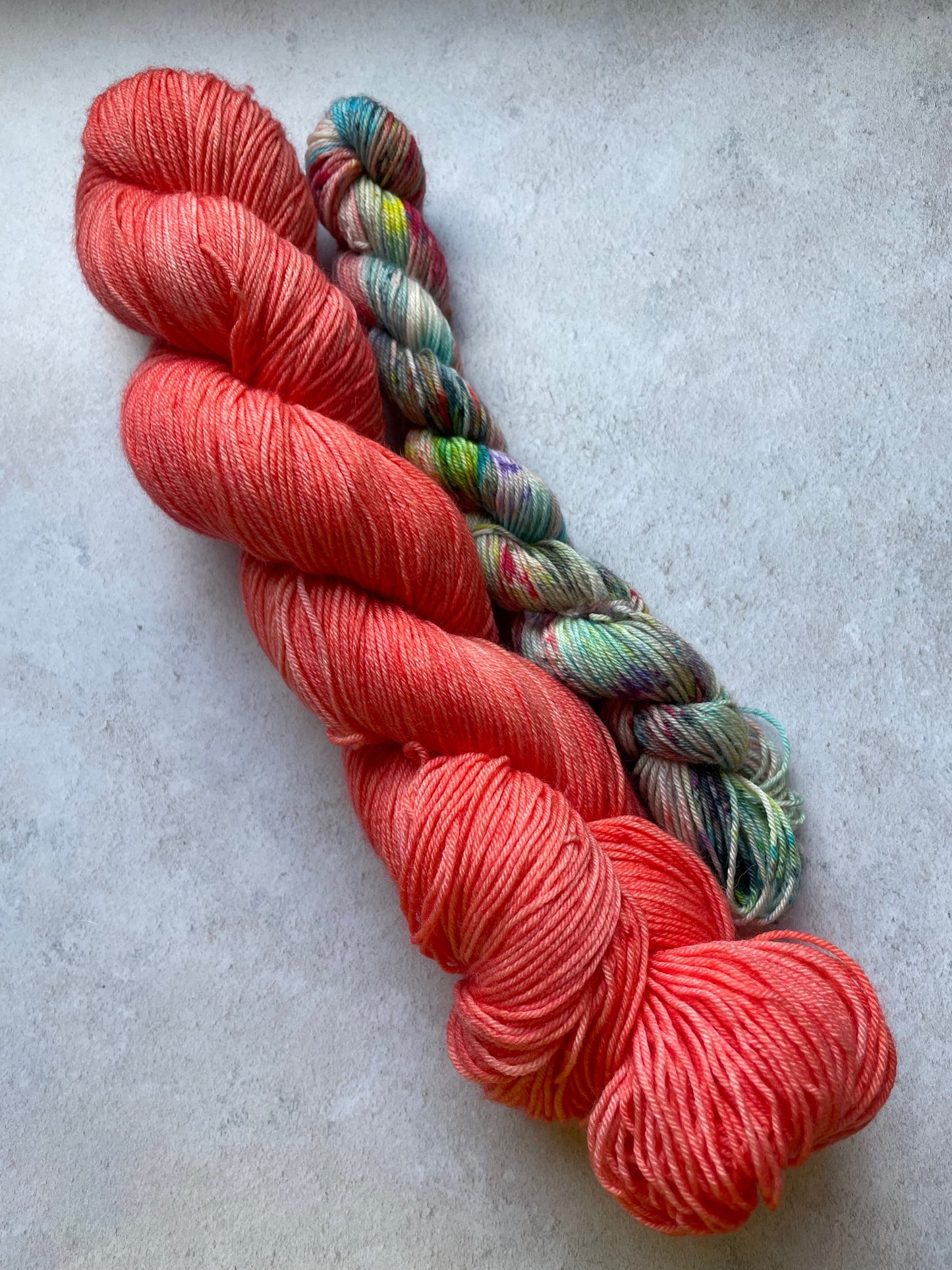120g sock set with red main skein and multicoloured mini skein