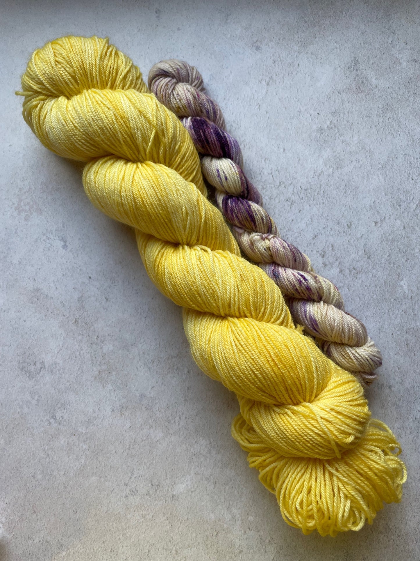 120g sock set with yellow main skein and purple and yellow mini skein