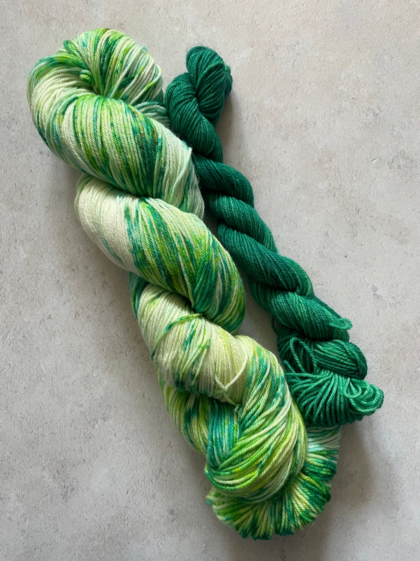 120g sock set with green speckled main skein and emerald mini skein