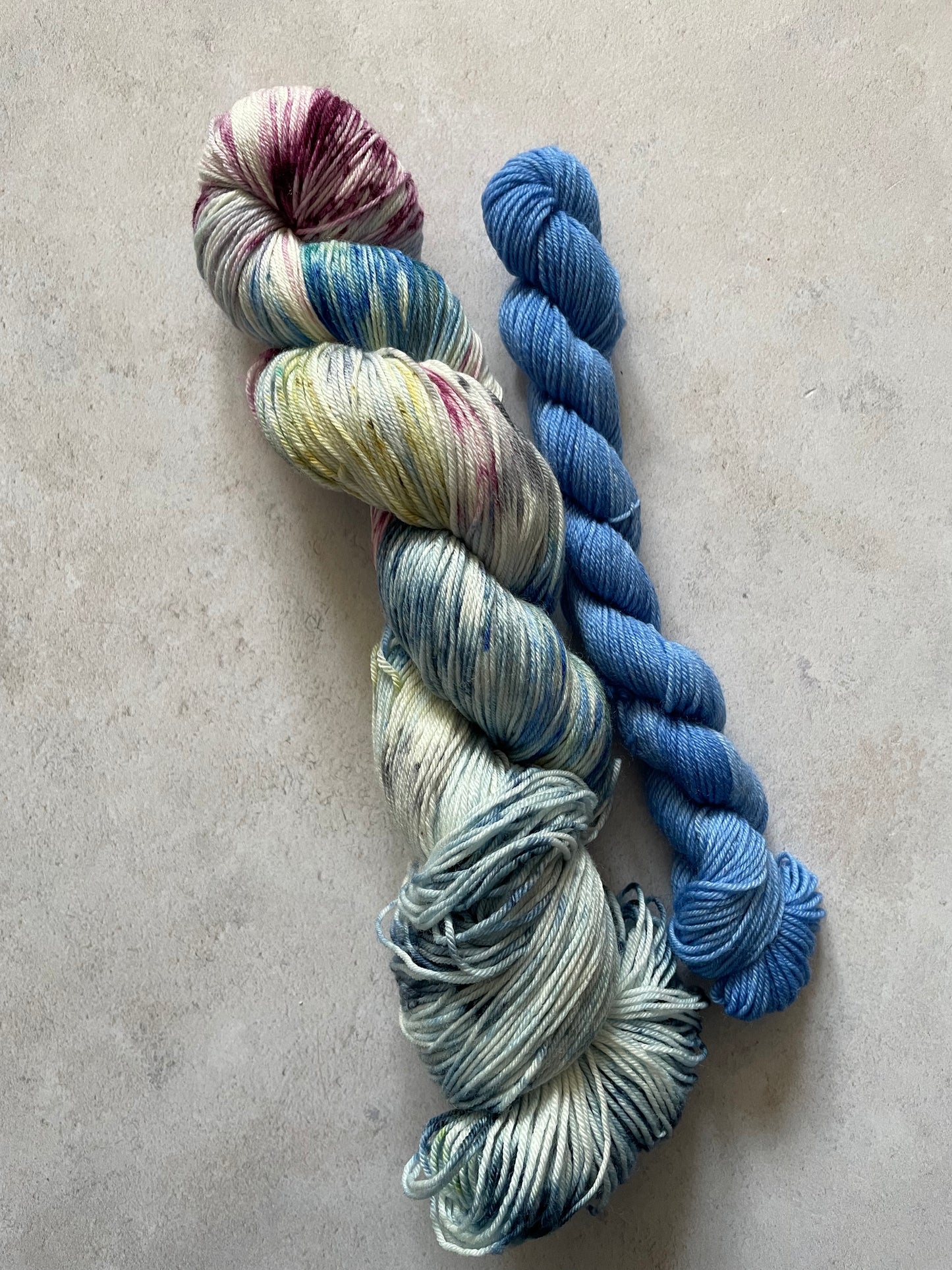 120g sock set with burgundy blue and green speckled main skein and blue mini skein