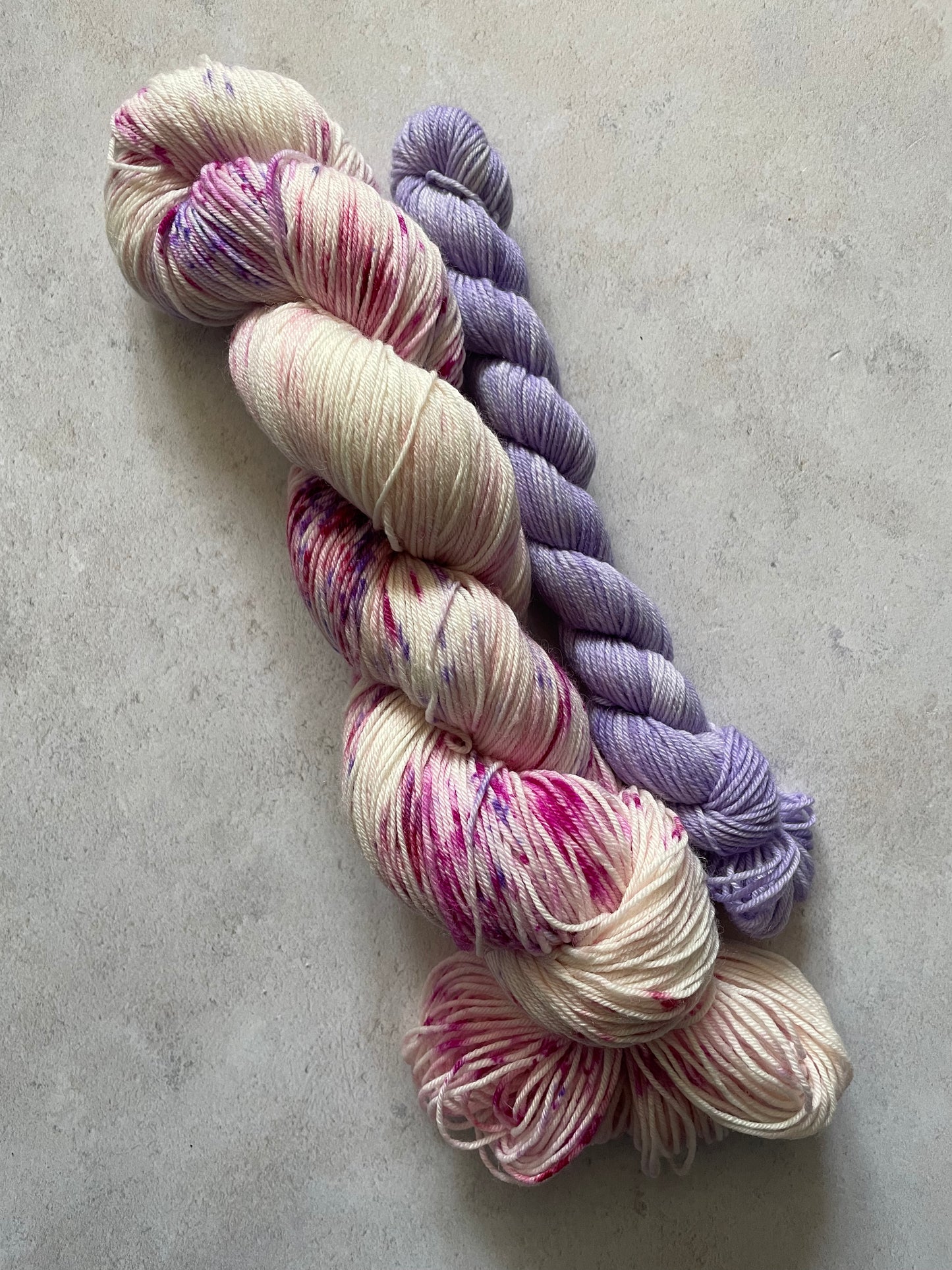 120g sock set with pink and purple speckled main skein and purple mini skein