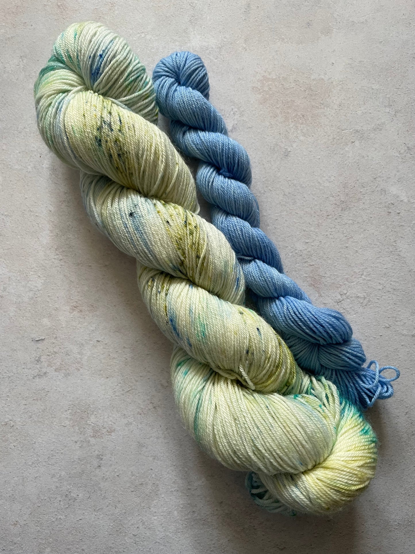 120g sock set lightly speckled with blue and green main skein and blue mini skein