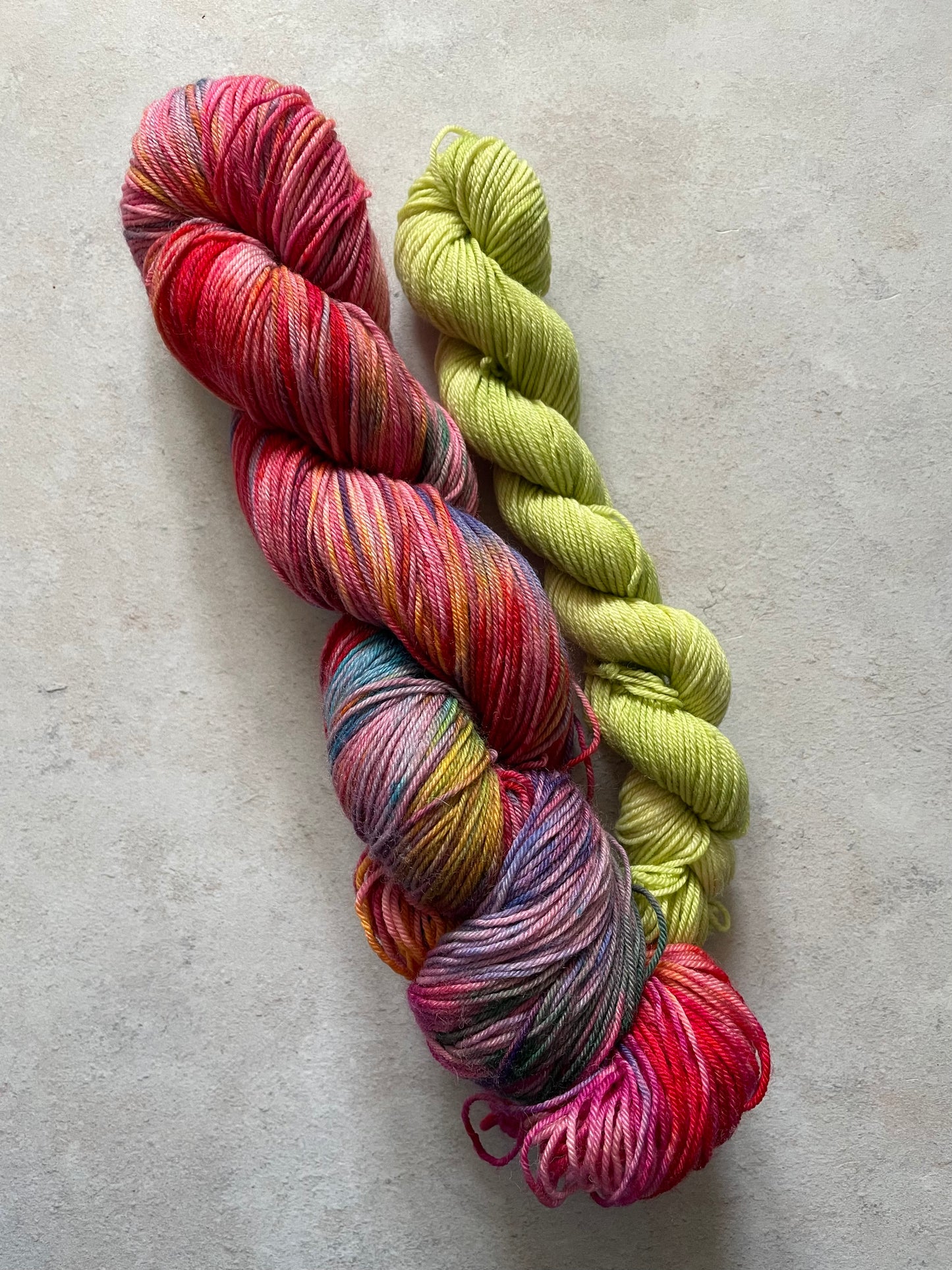 120g sock set with red and multicoloured main skein and lime mini skein