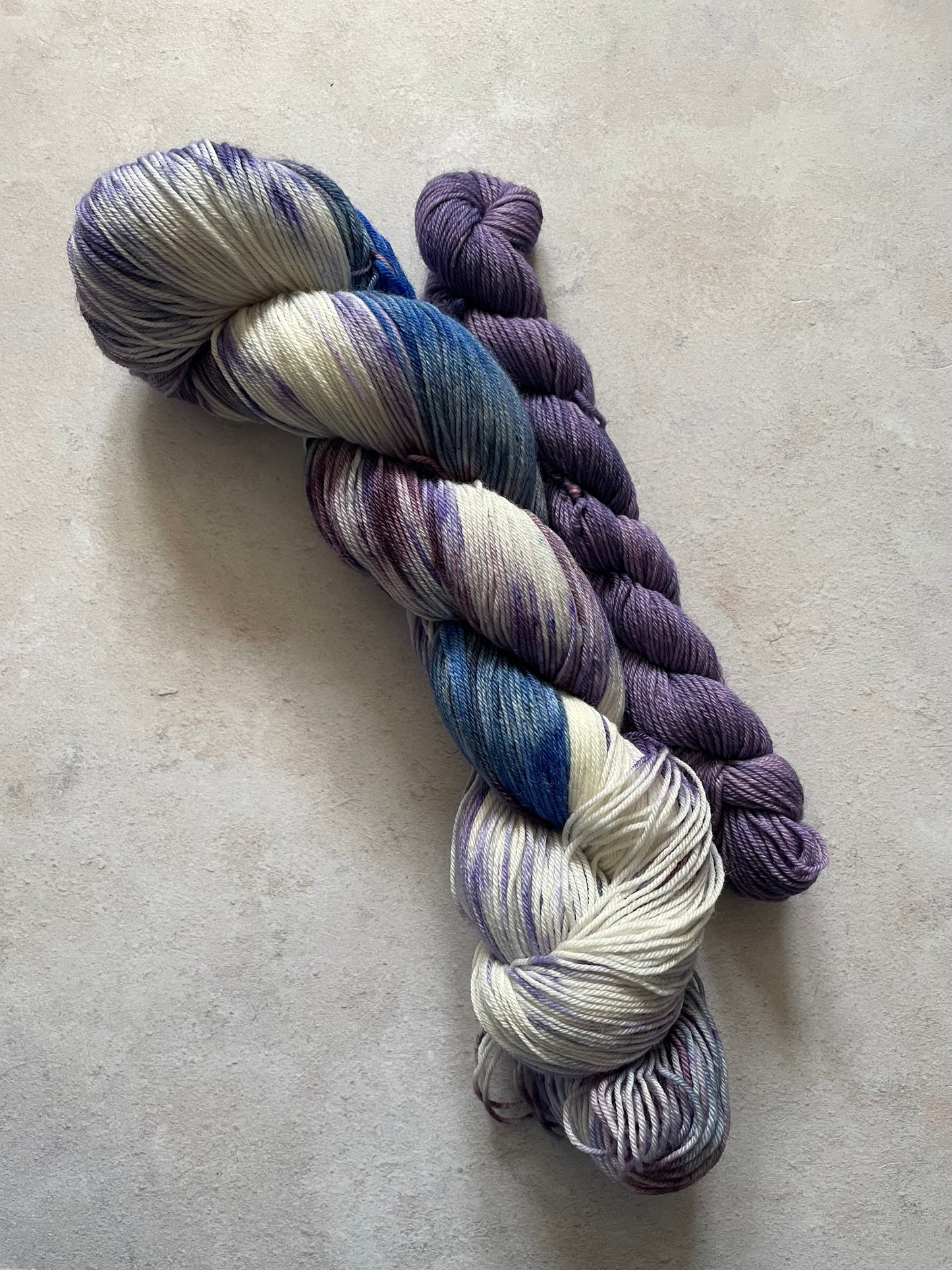120g sock set with cream blue and purple main skein and purple mini skein