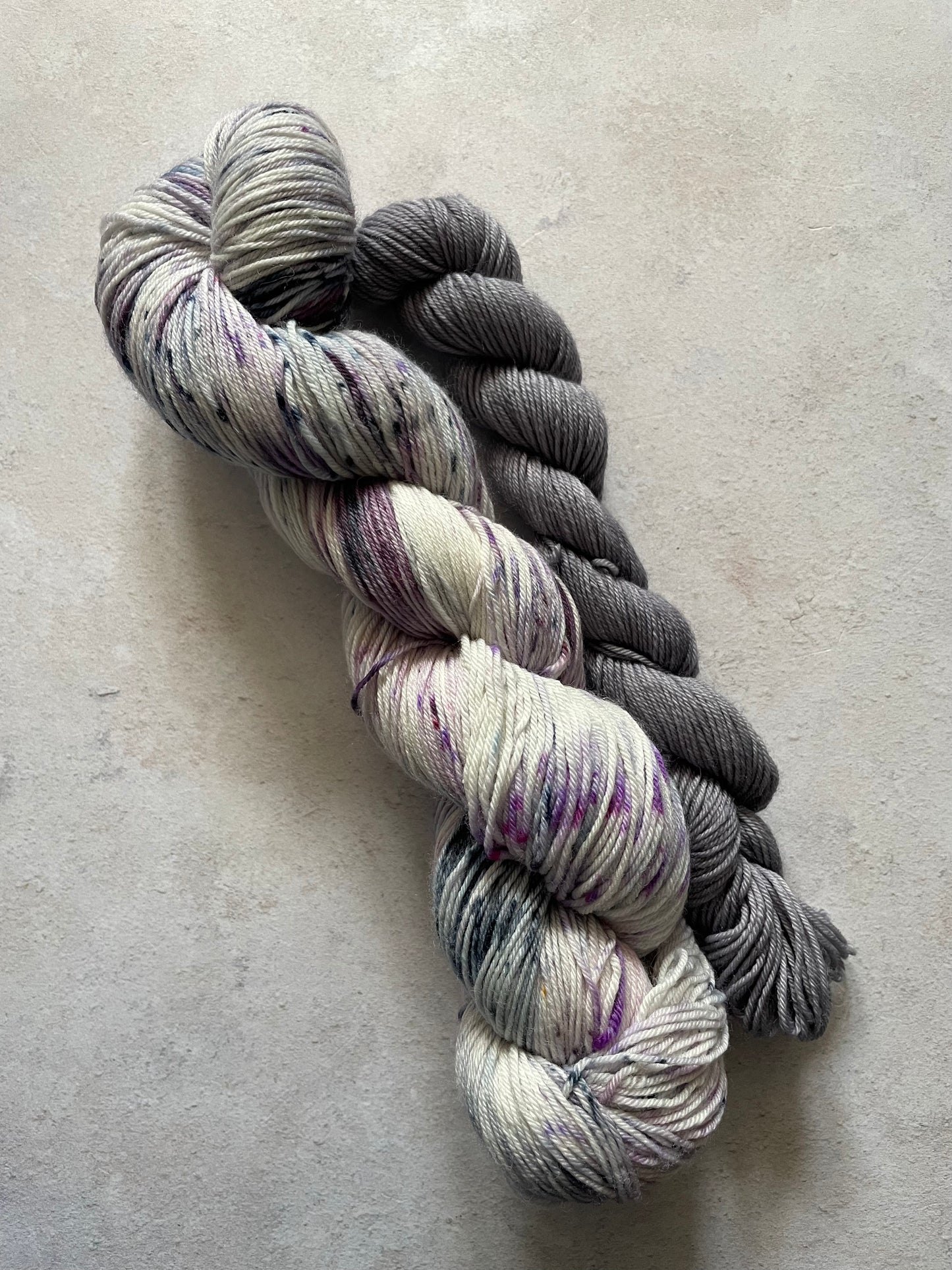 120g sock set with purple and grey speckled main skein and grey mini skein