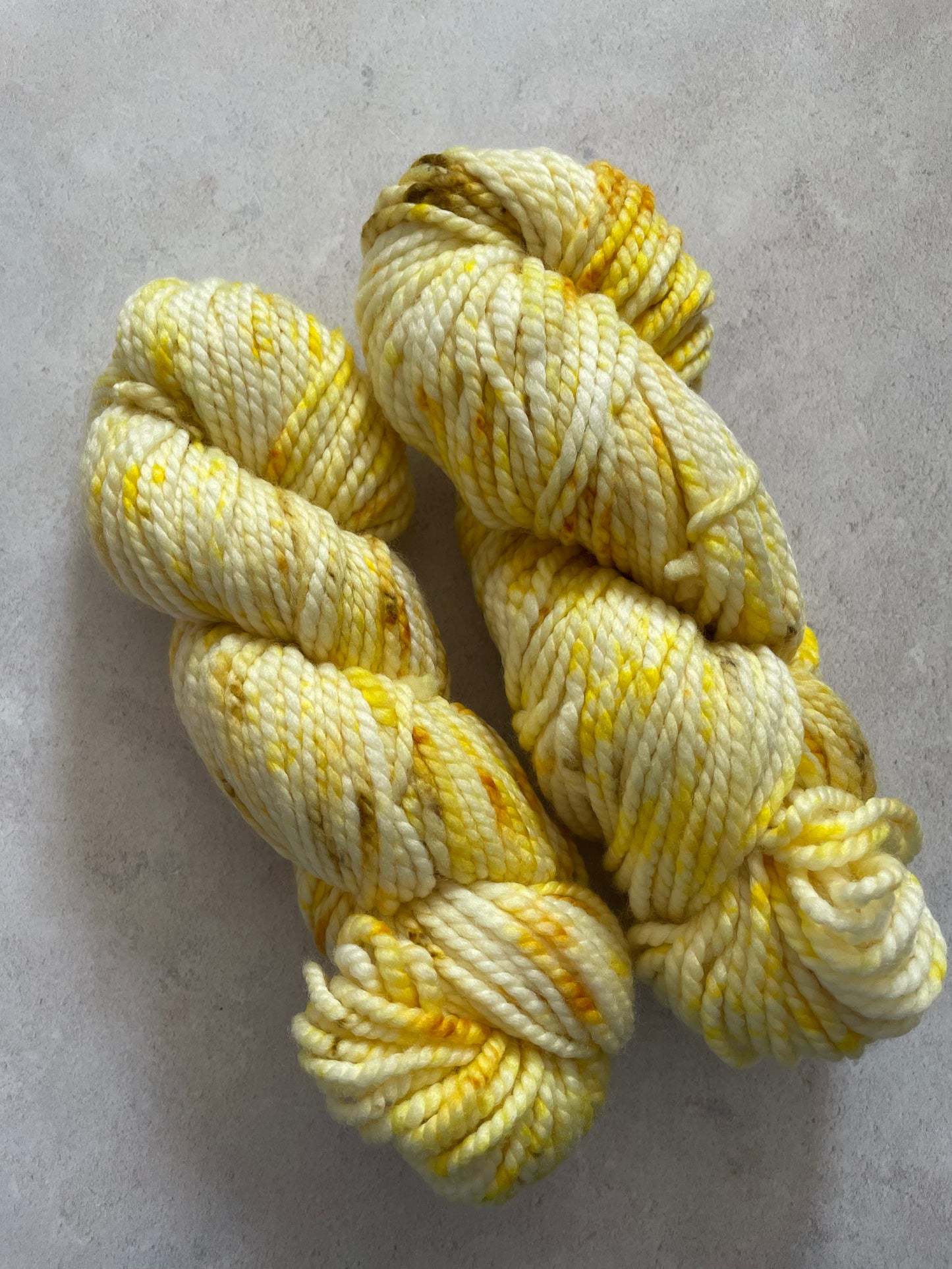 Chunky yarn skeins speckled with shades of yellow