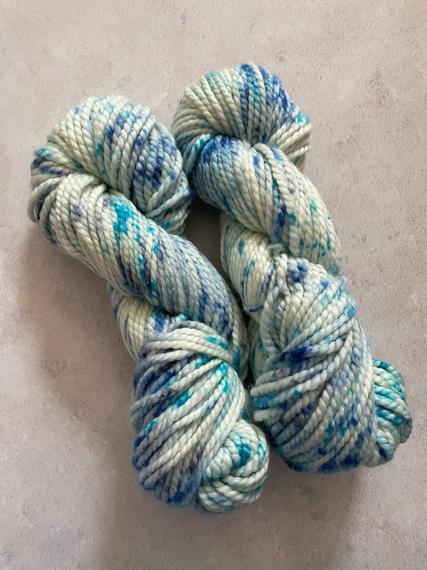 Chunky yarn skeins speckled with different shades of blue
