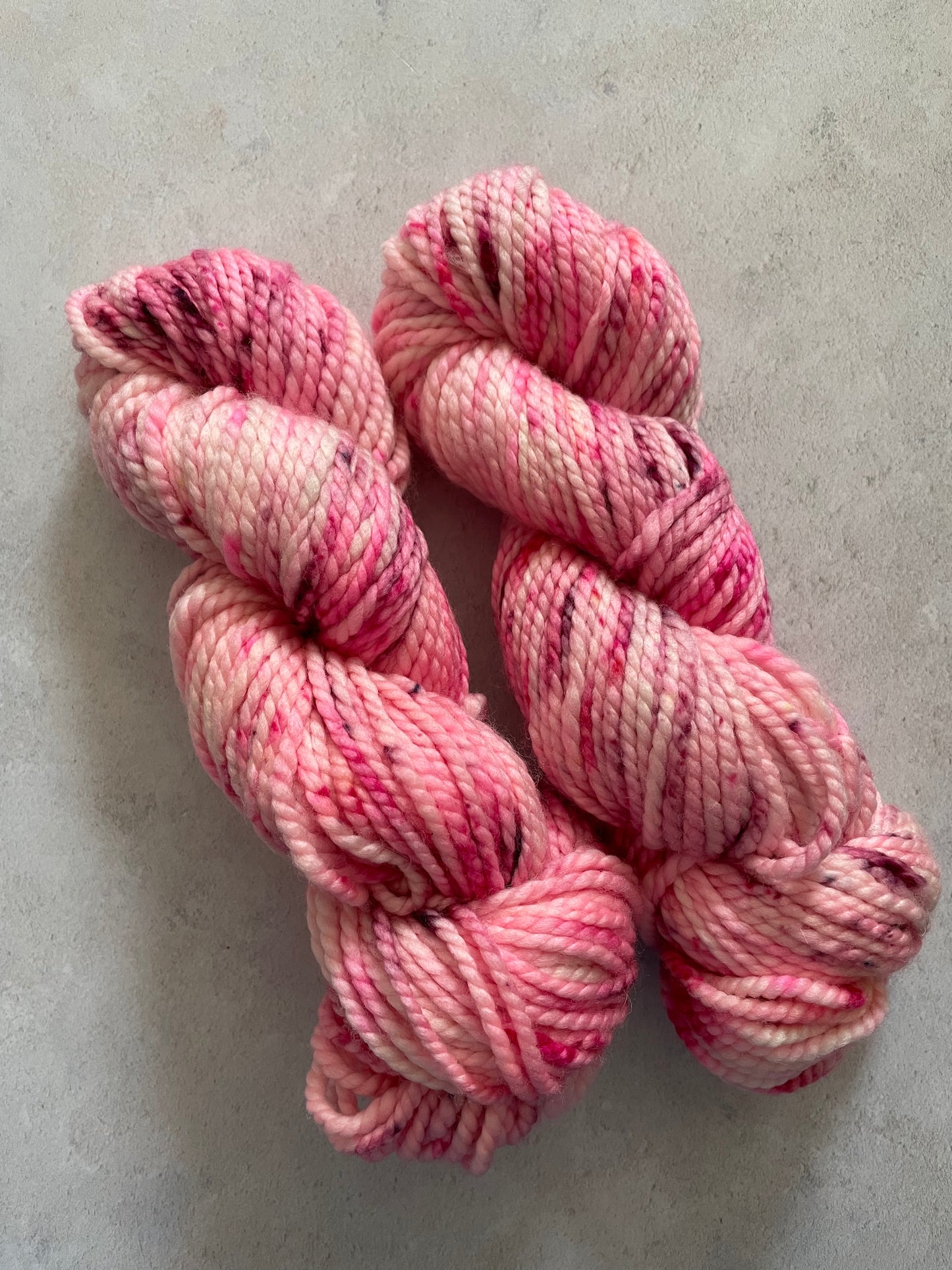 Chunky yarn skeins speckled with shades of pink