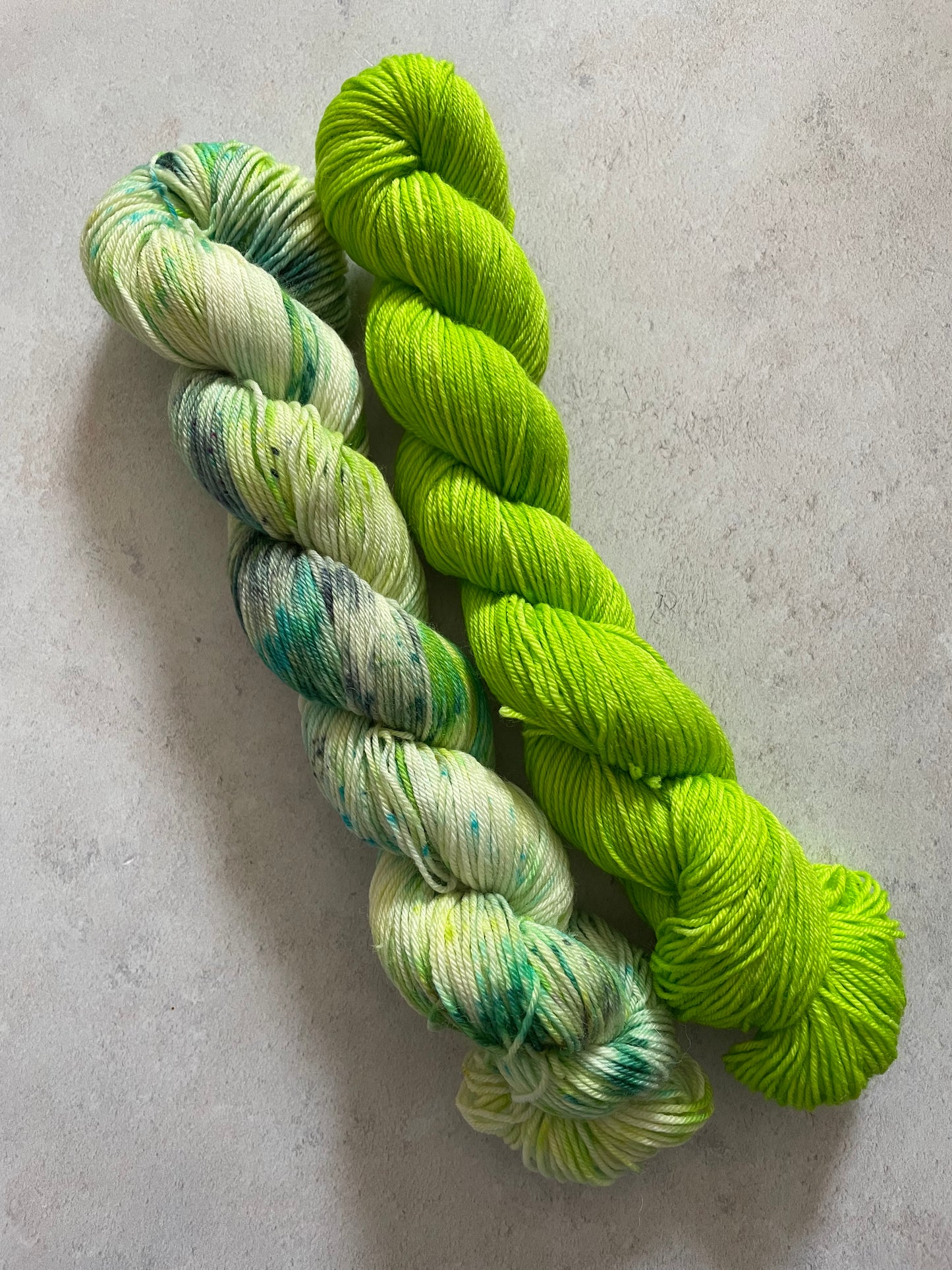 One 50g variegated green skein and one 50g lime skein