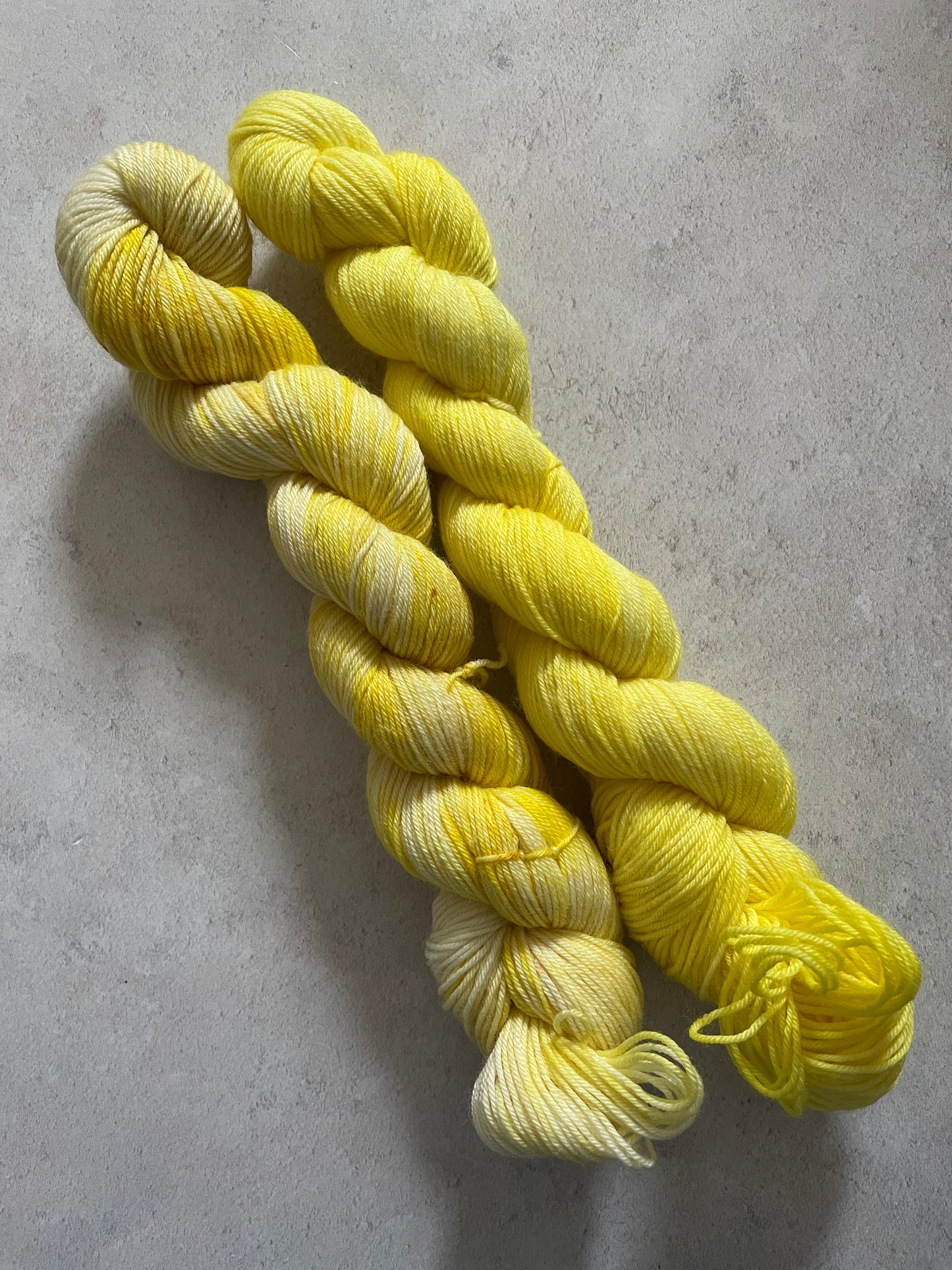 One 50g variegated bright yellow skein and one 50g bright yellow skein