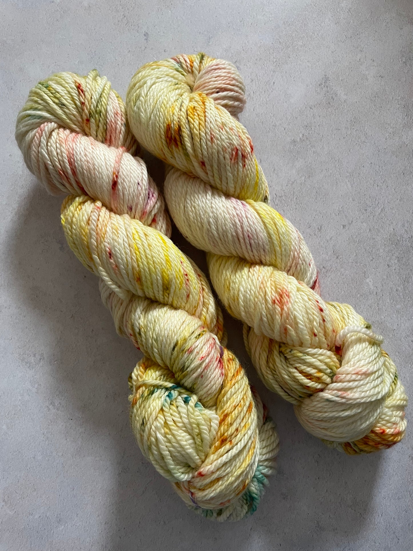 Yellow Aran yarn with red and green speckles