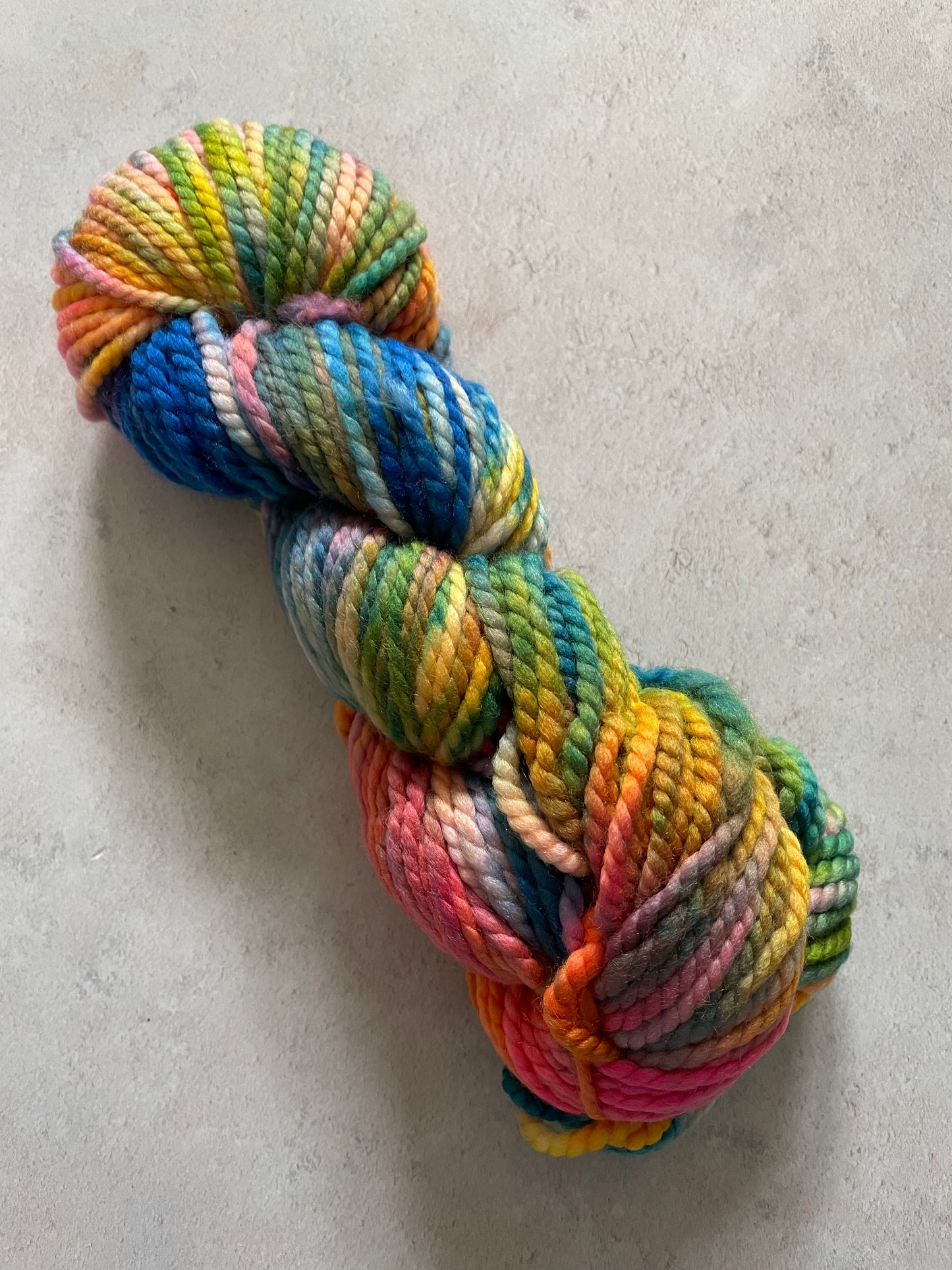 Multicoloured chunky skein with pink orange yellow green and blue