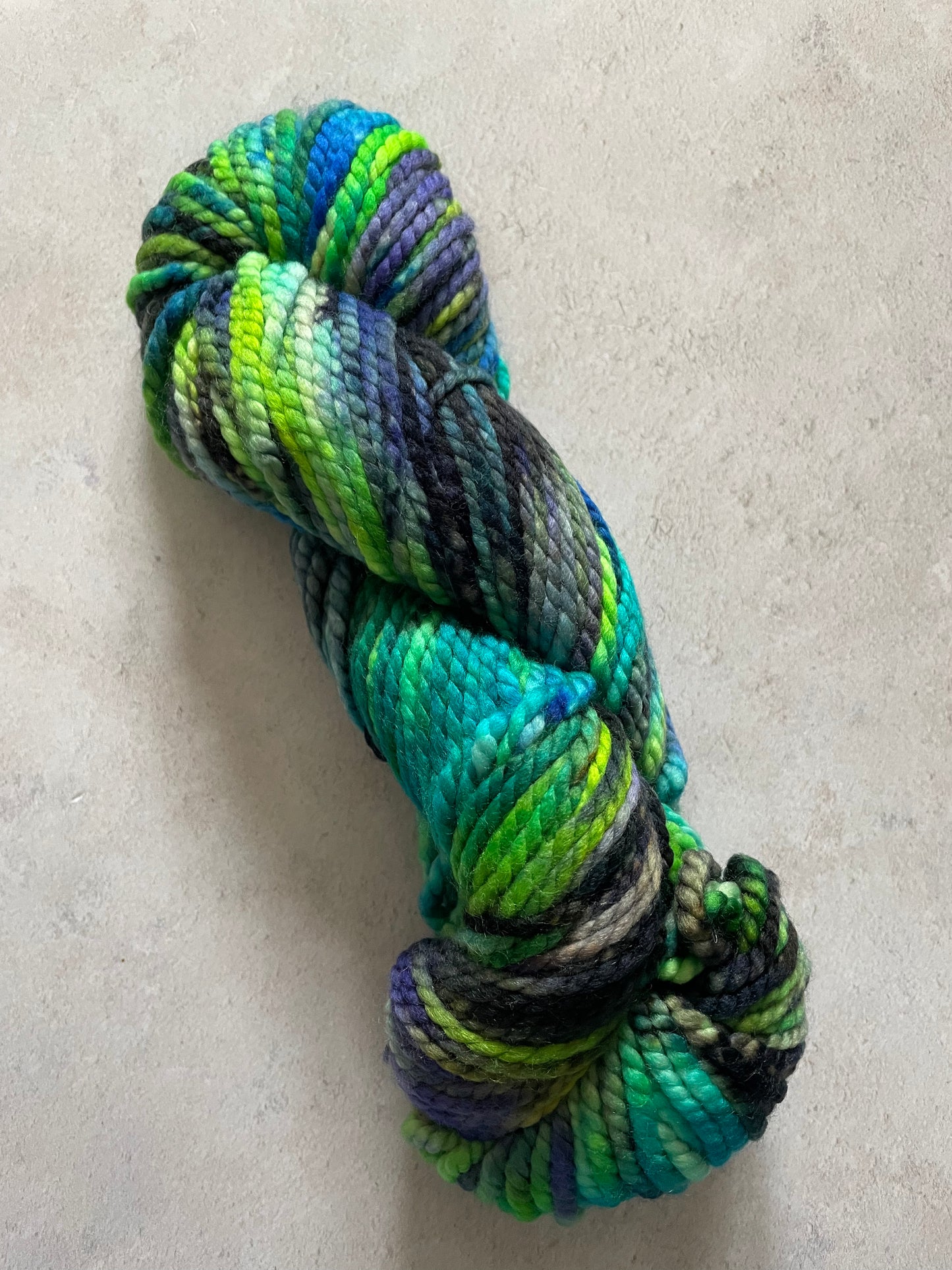 Chunky skein with black green blue purple and turquoise