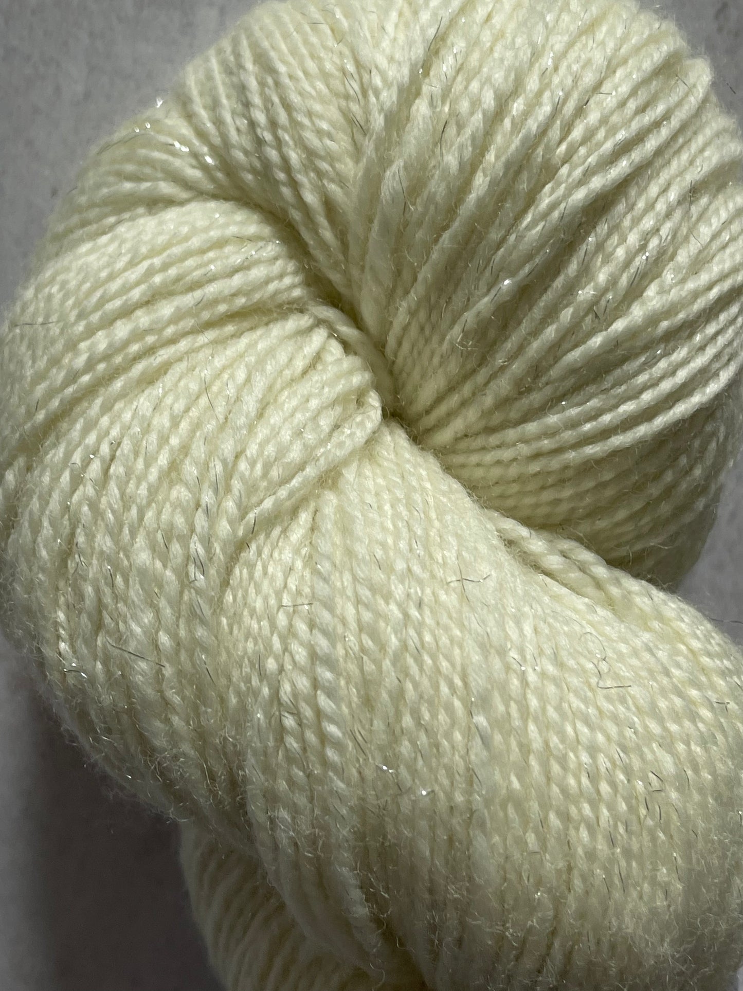 A close up of undyed silver sparkle sock