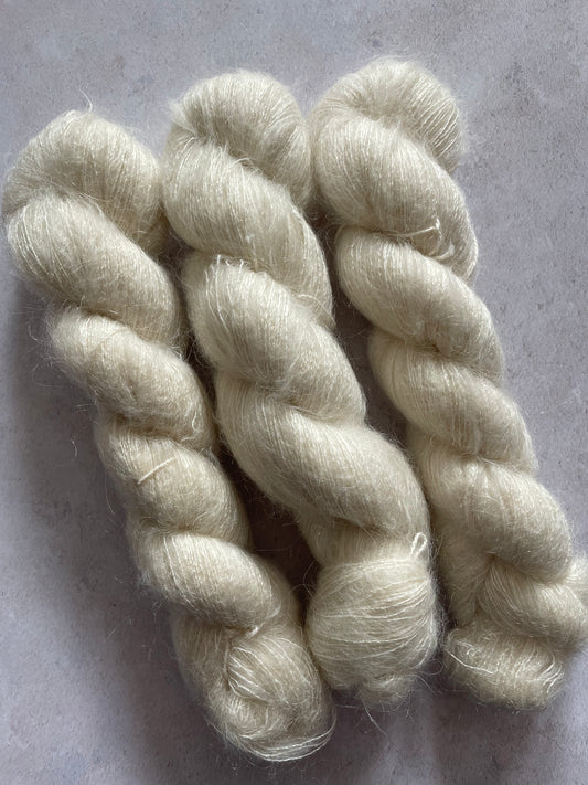 Three skeins of undyed kid mohair and silk yarn