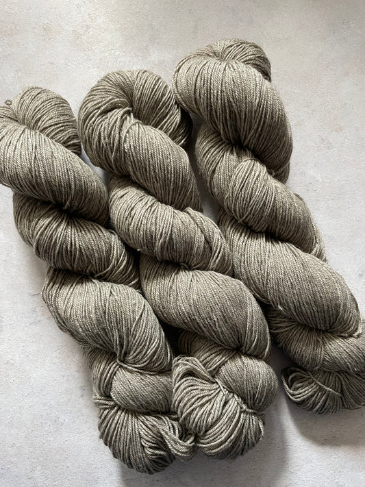 Three skeins of undyed grey yak sock yarn