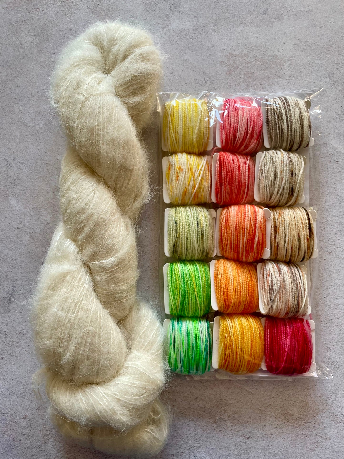 50g of our suri alpaca and silk base with 15 5g bobbins of scrappy yarn