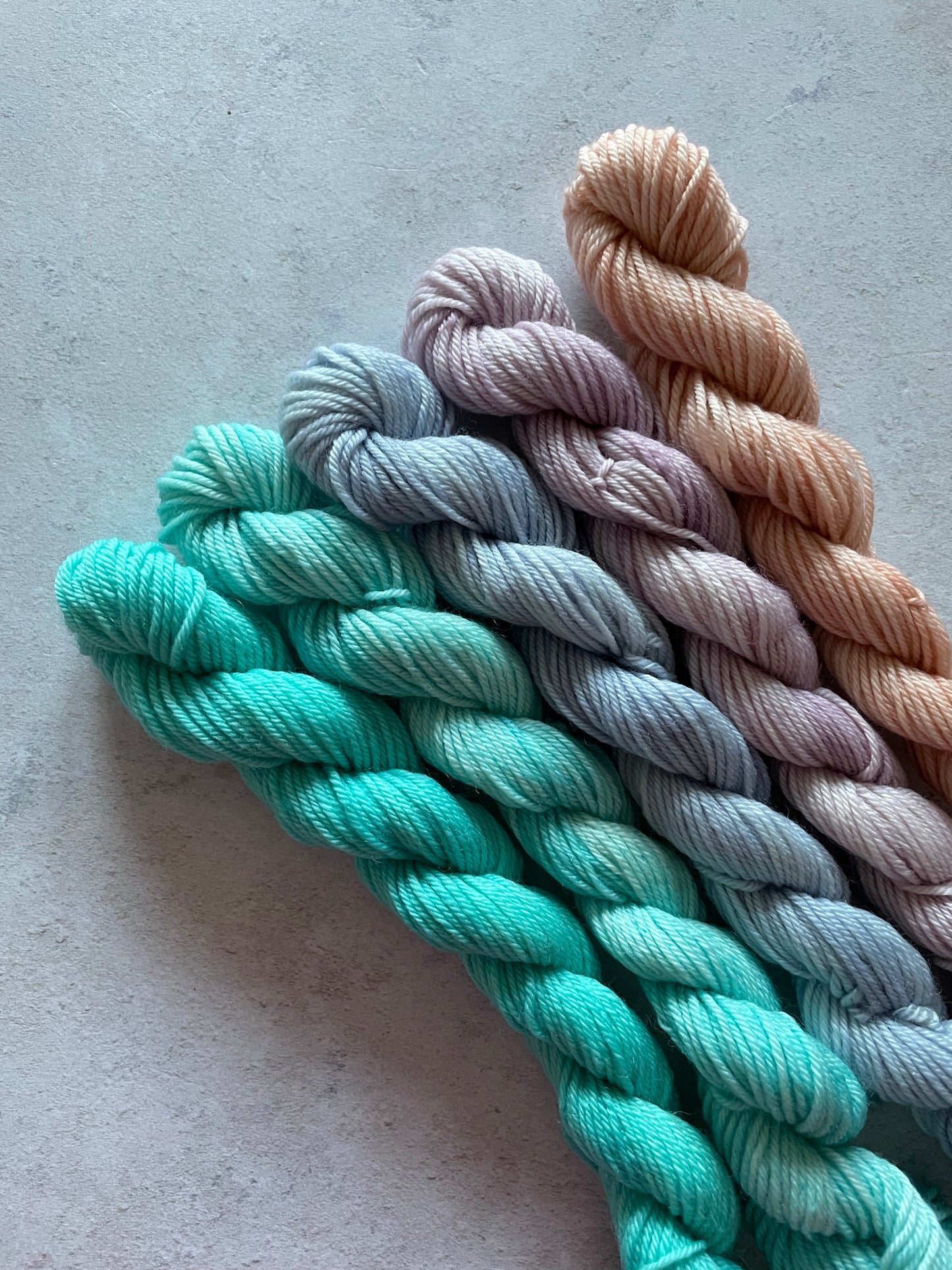5 mini skeins in shades of aqua lilac and peach