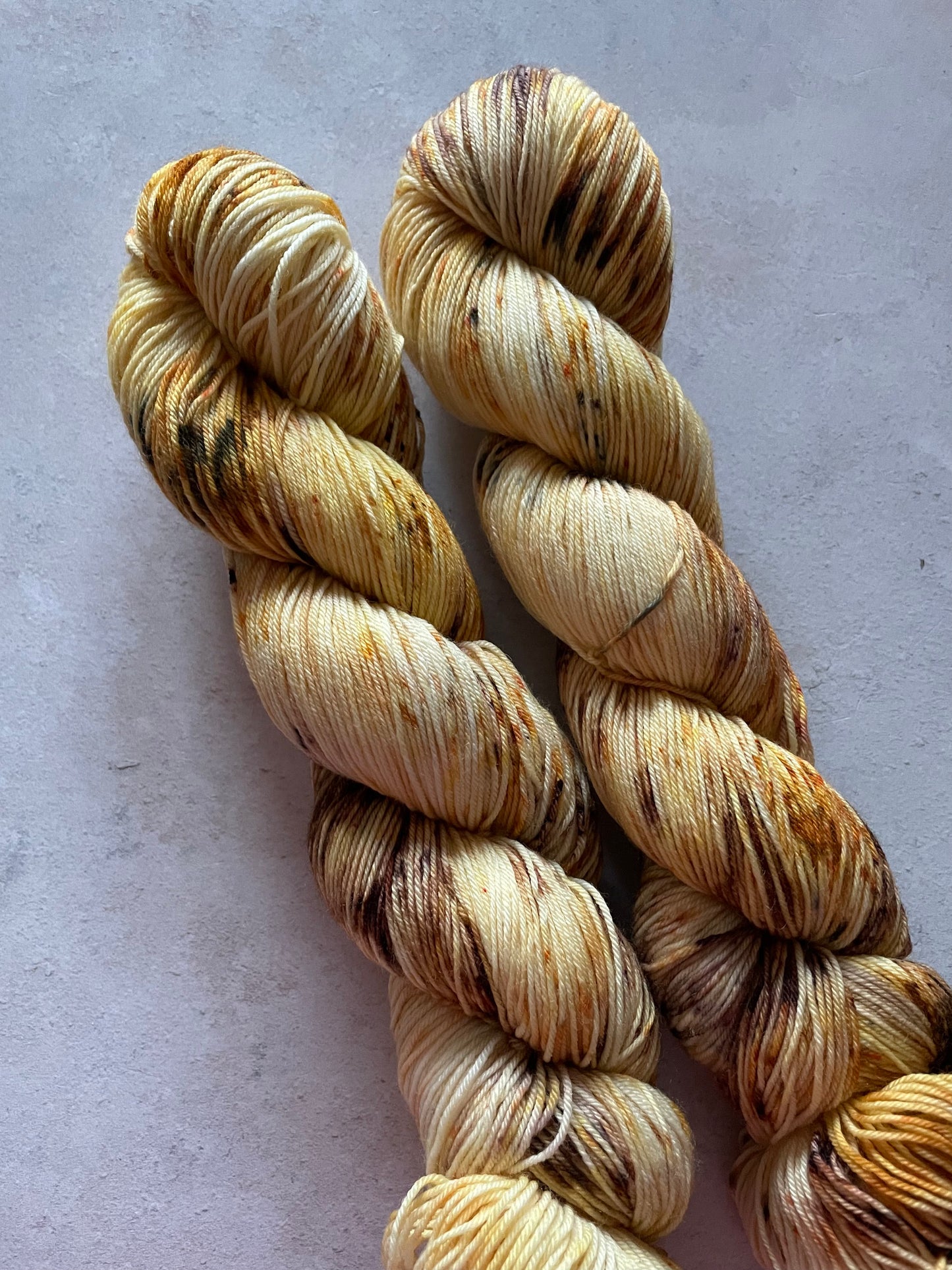 2 skeins of yarn in golds and browns