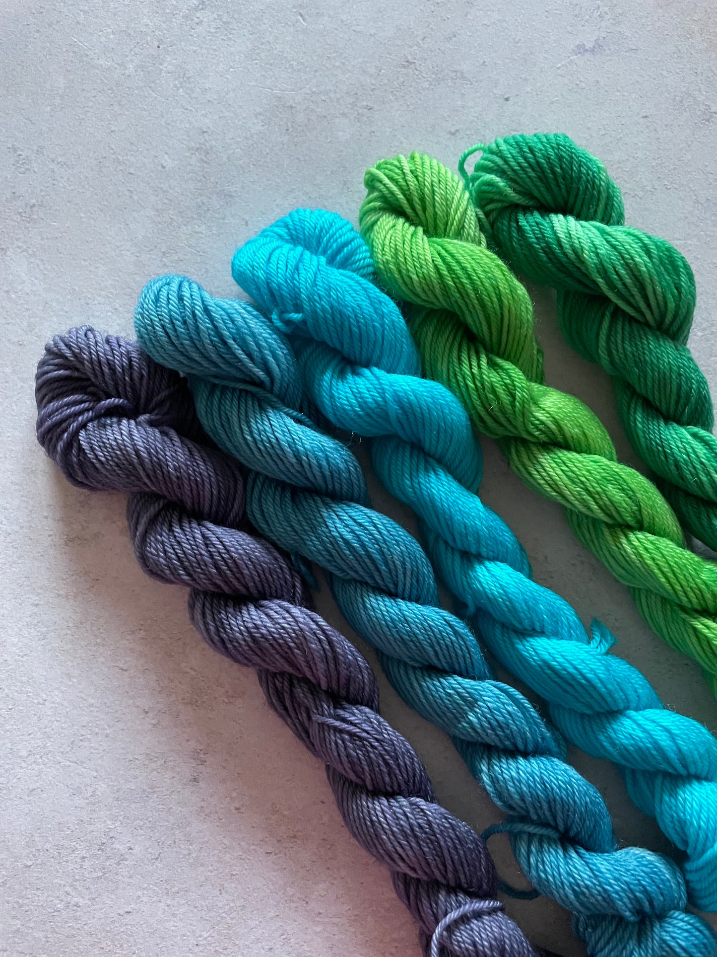 5 mini skeins in shades of blue and green