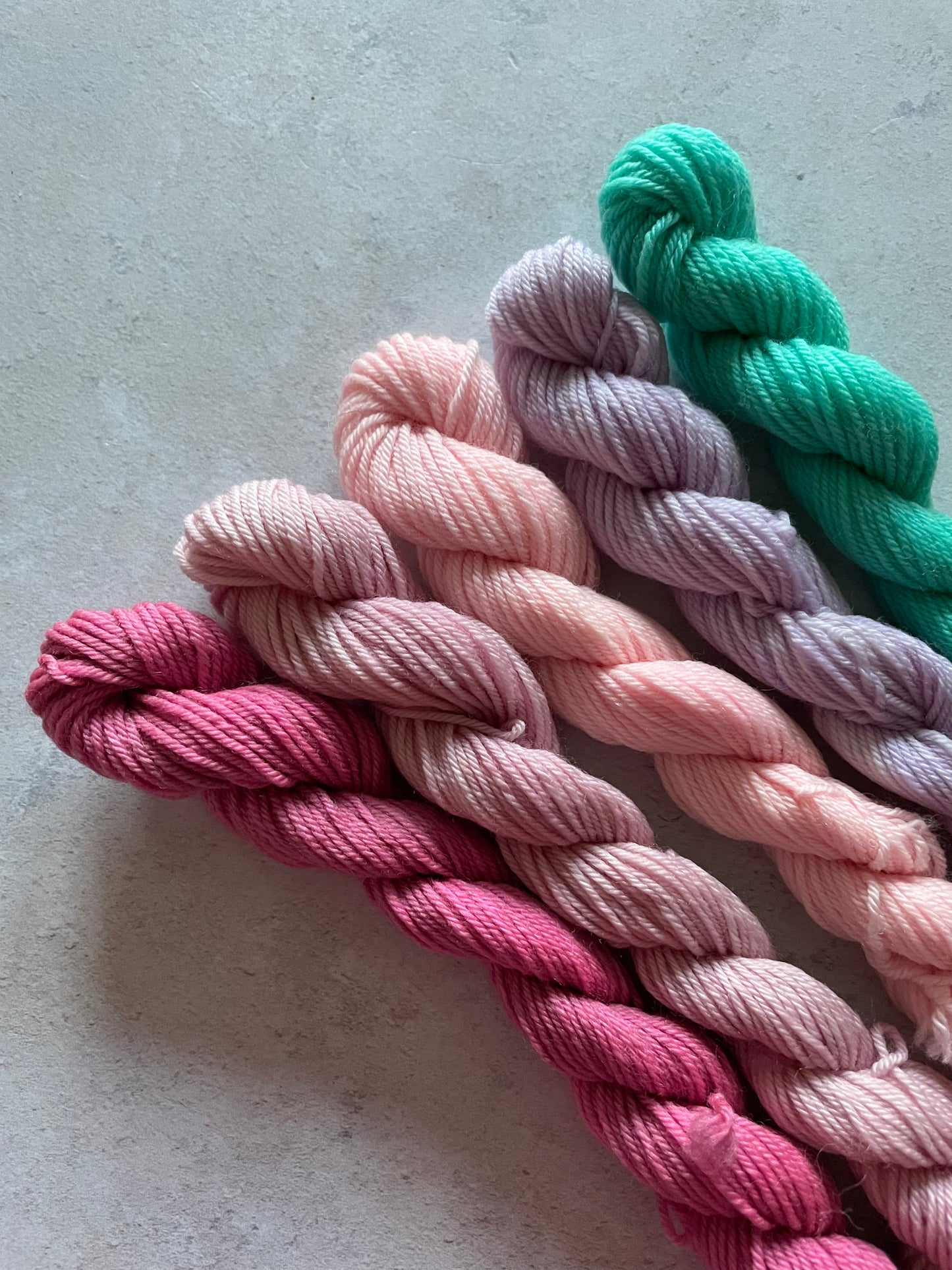 5 mini skeins in shades of pink lilac and green