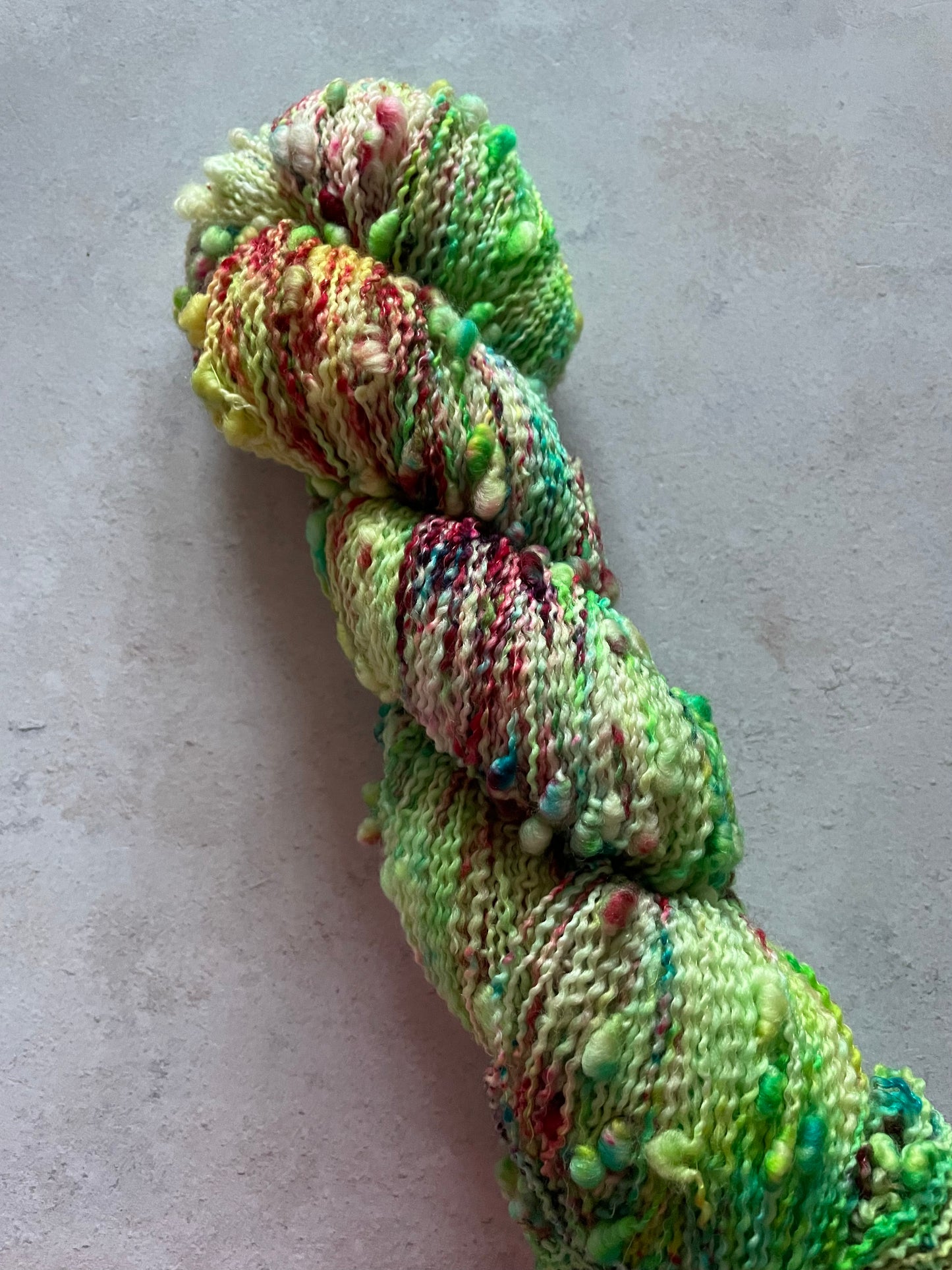 Textured slub skein with greens and reds