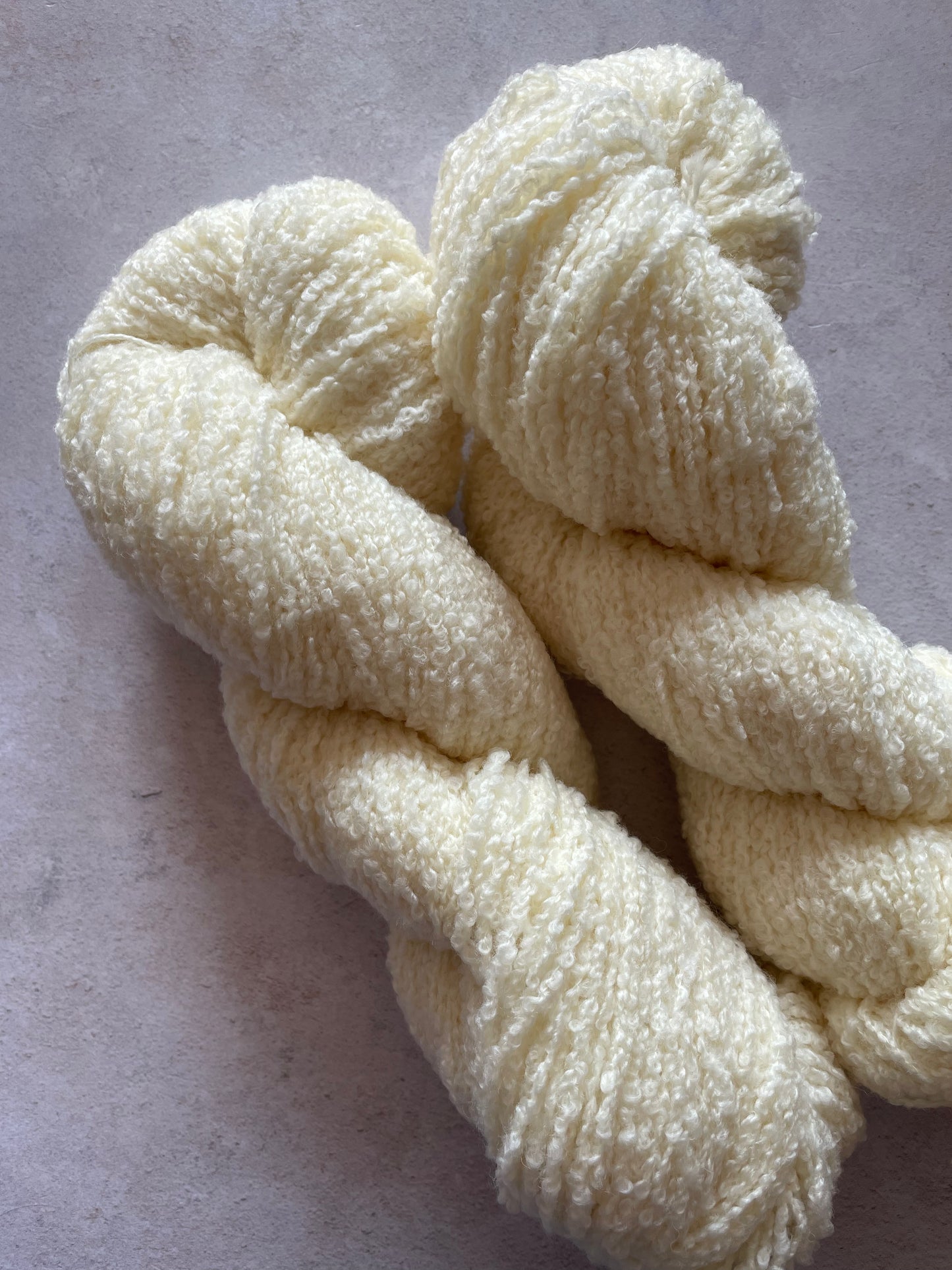 Two skeins of cream coloured textured yarn