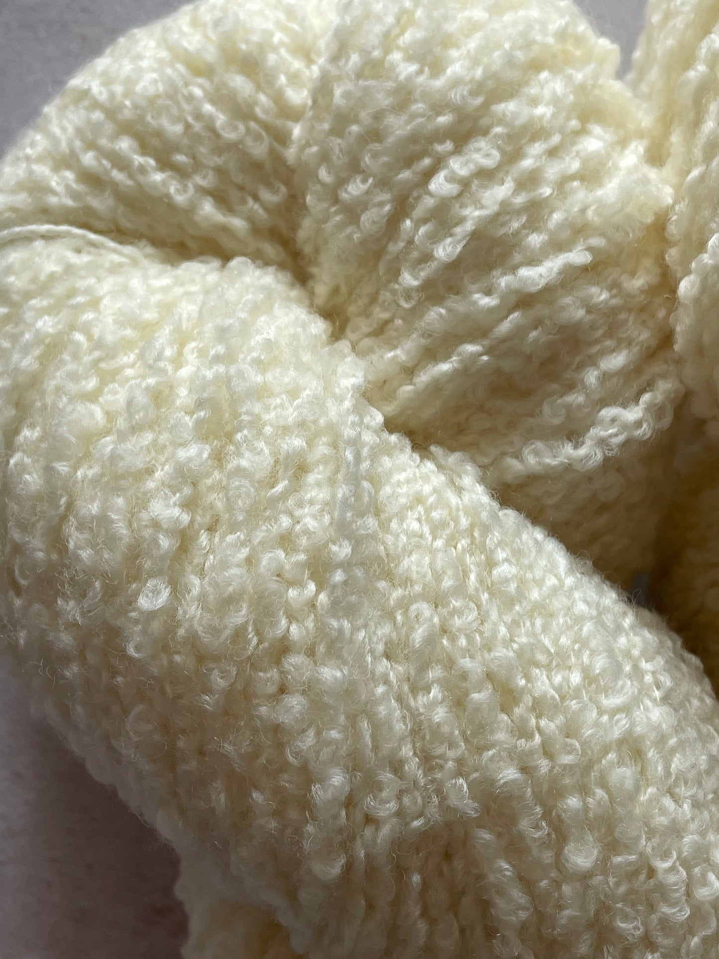 A close up of cream coloured textured yarn