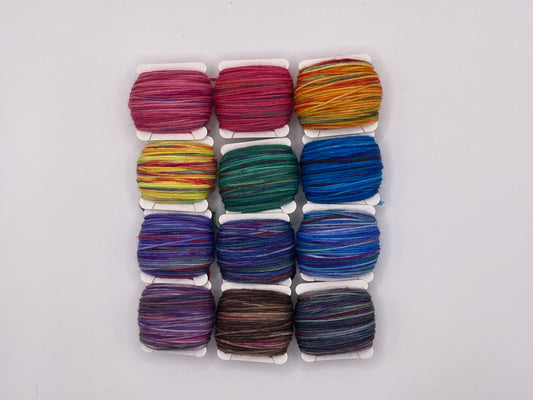 12 yarn bobbins in a rainbow of colours