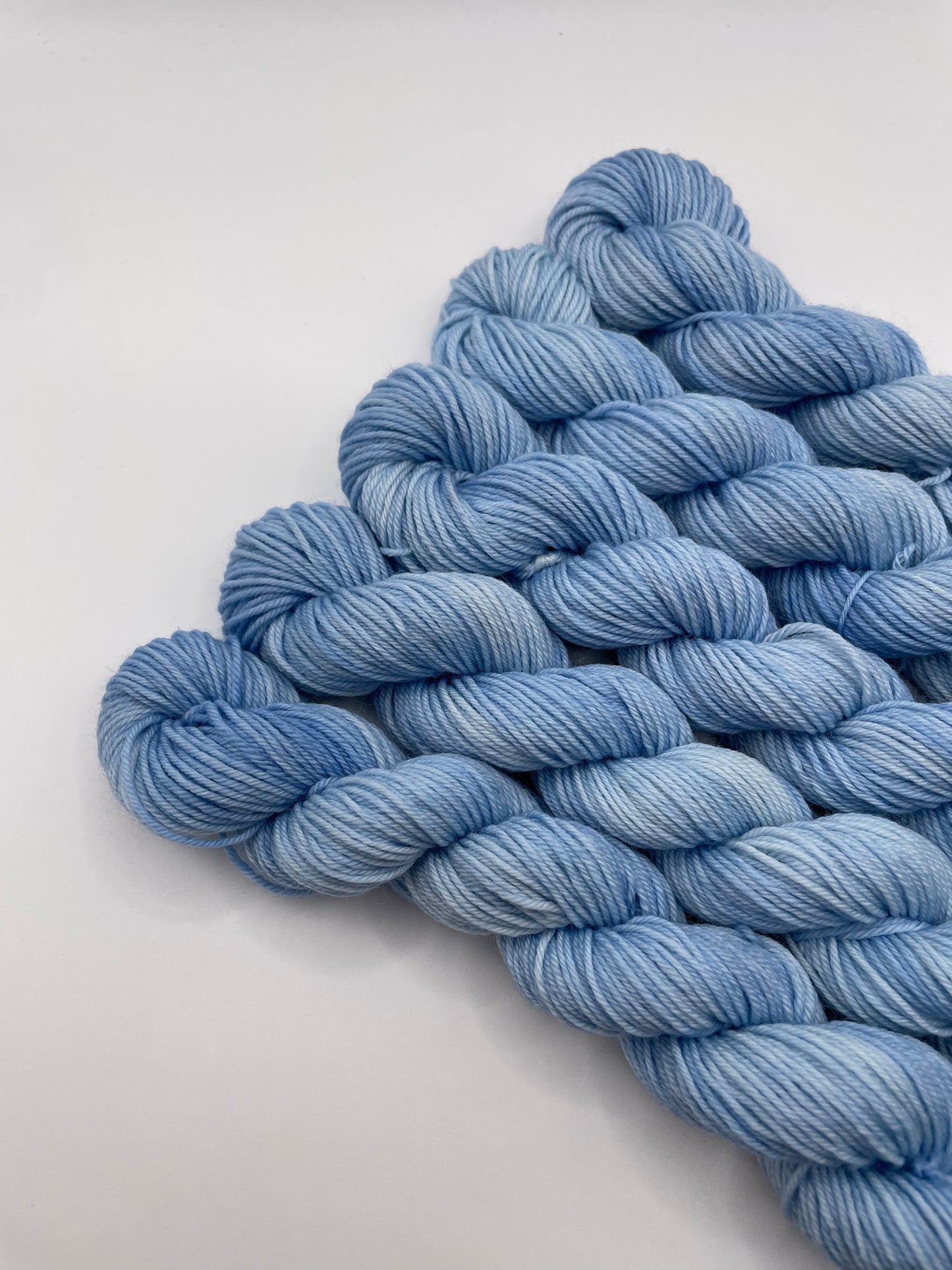 Blue yarn mini skeins on a white background