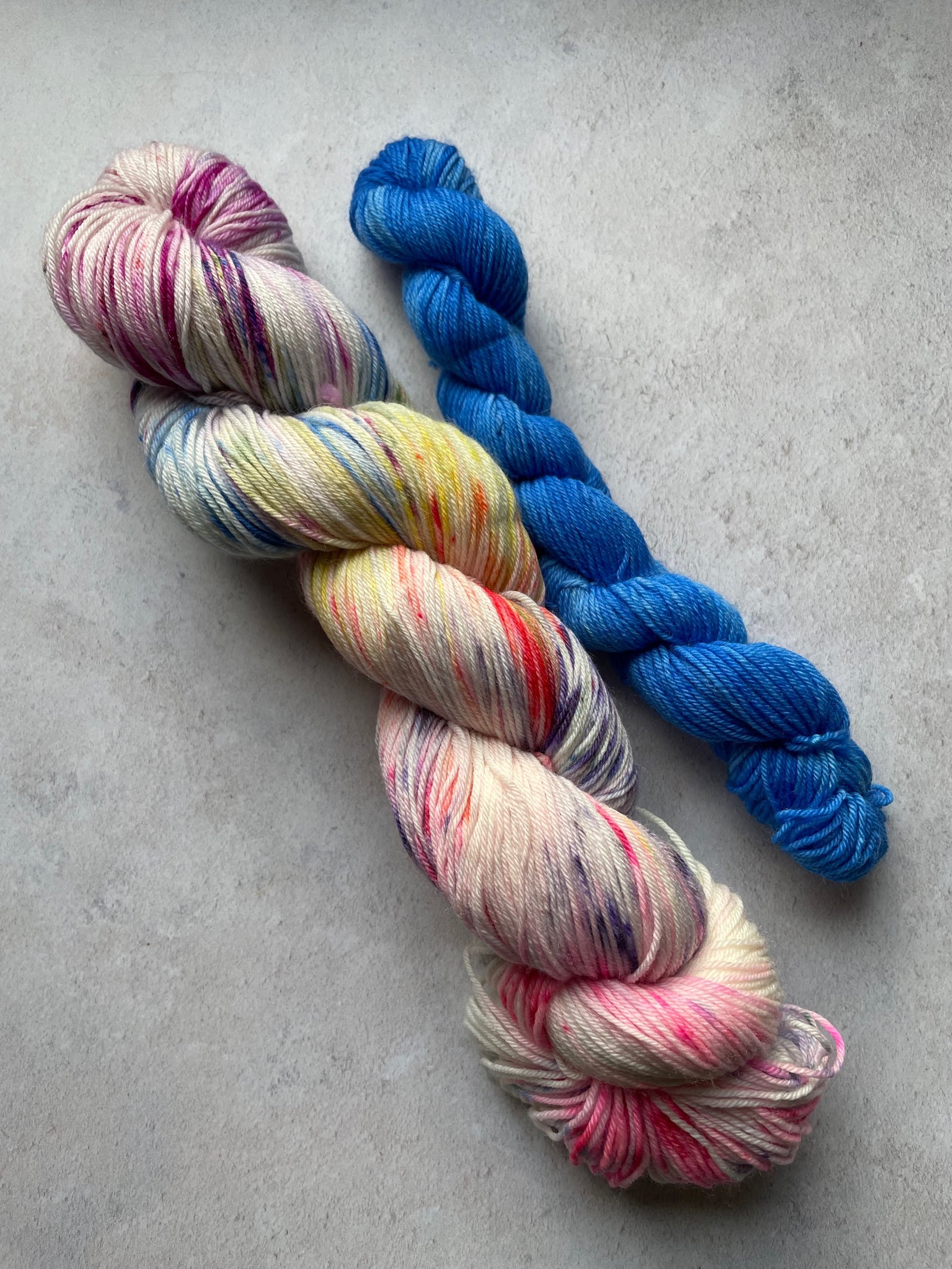 120g sock set with multicoloured main skein and blue mini skein