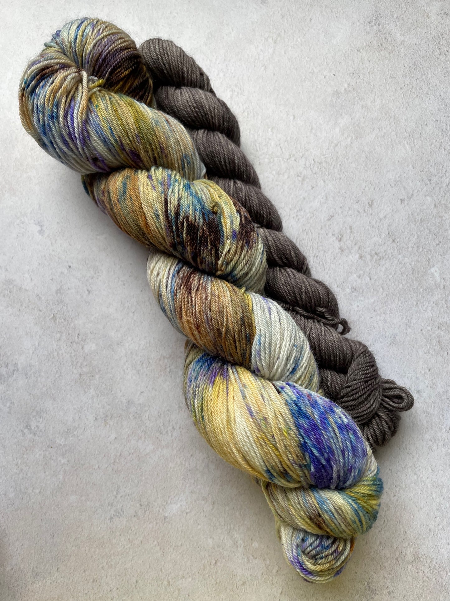 120g sock set with brown gold and blue speckled main skein and brown mini skein