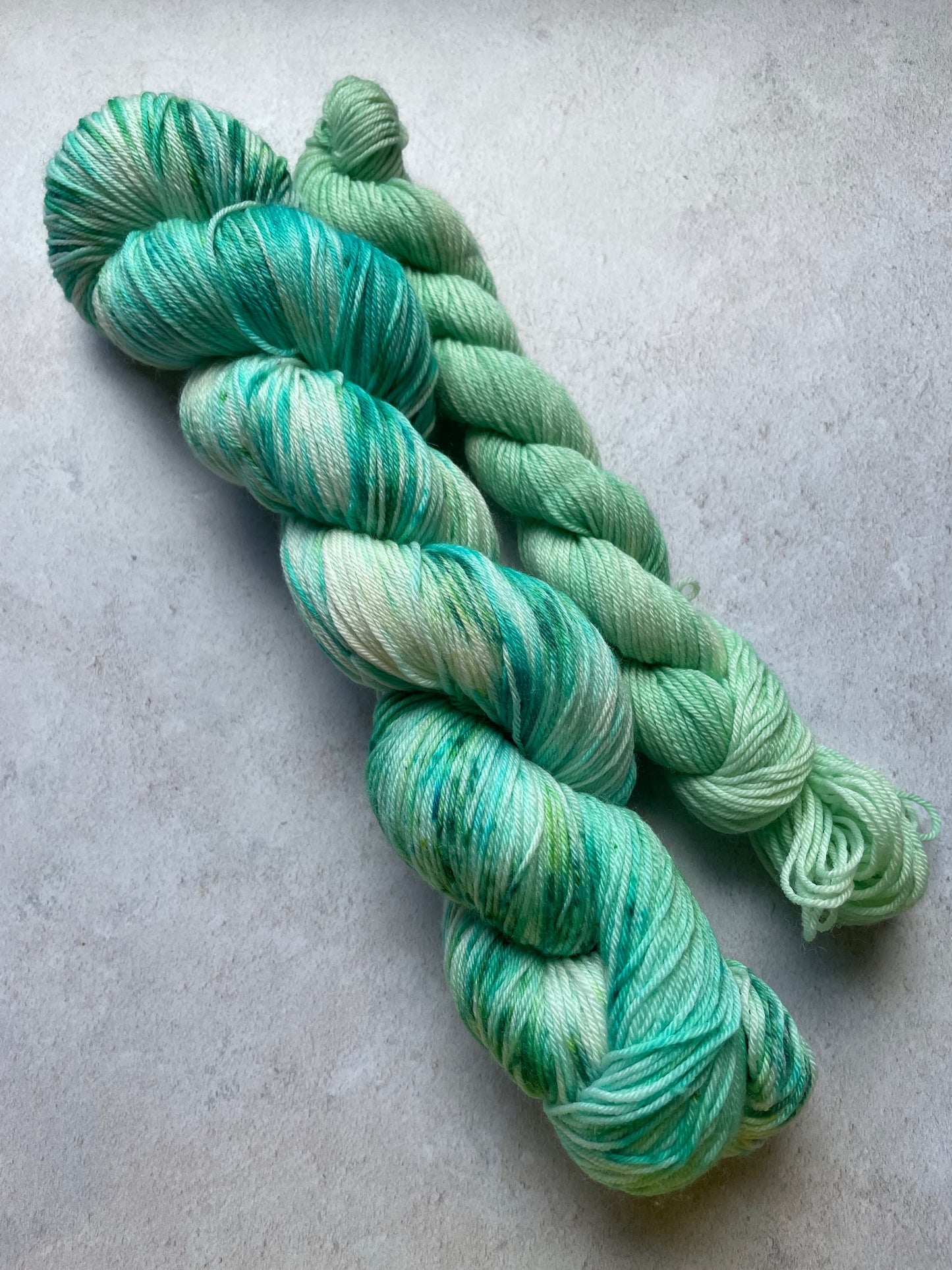 120g sock set with aqua and green speckled main skein and pale green mini skein