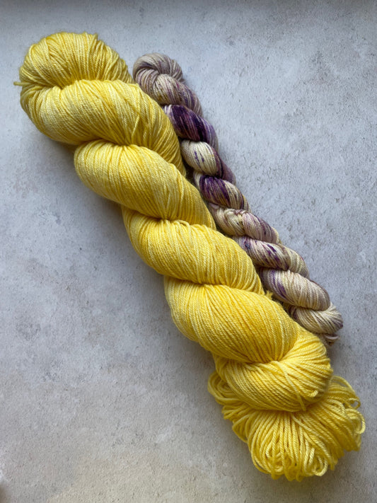 120g sock set with yellow main skein and purple and yellow mini skein