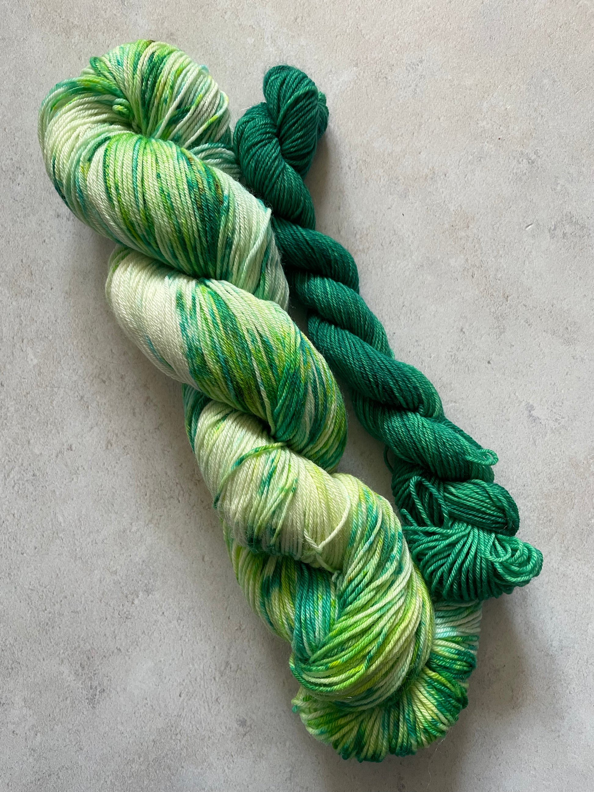 120g sock set with green speckled main skein and emerald mini skein