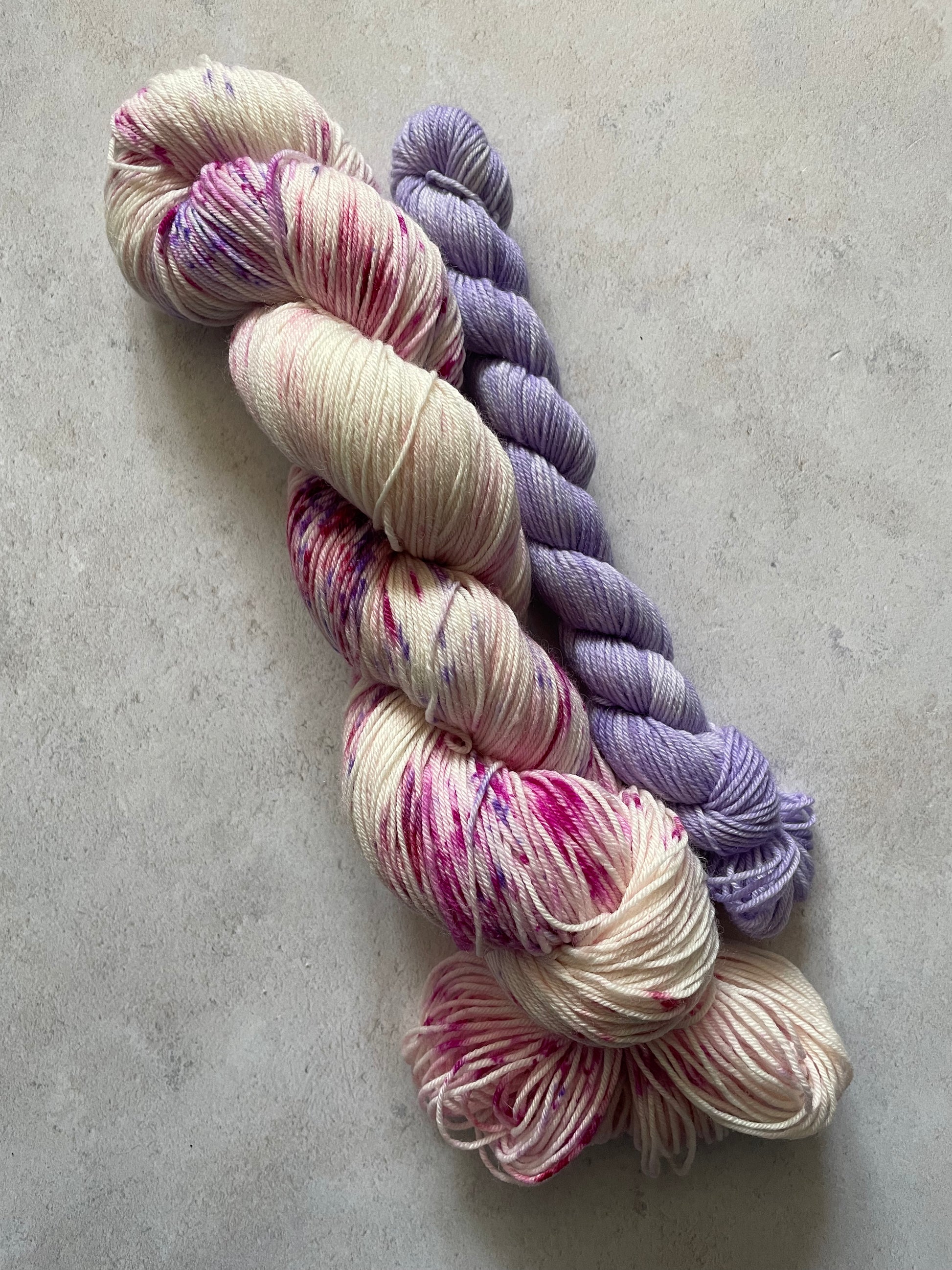 120g sock set with pink and purple speckled main skein and purple mini skein