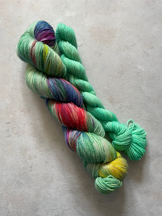120g sock set with green and rainbow main skein and green mini skein