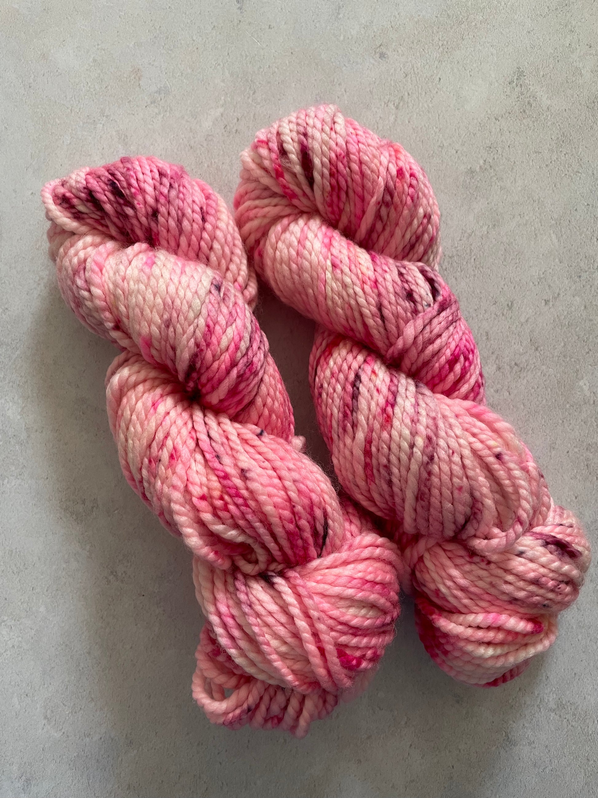 Chunky yarn skeins speckled with shades of pink