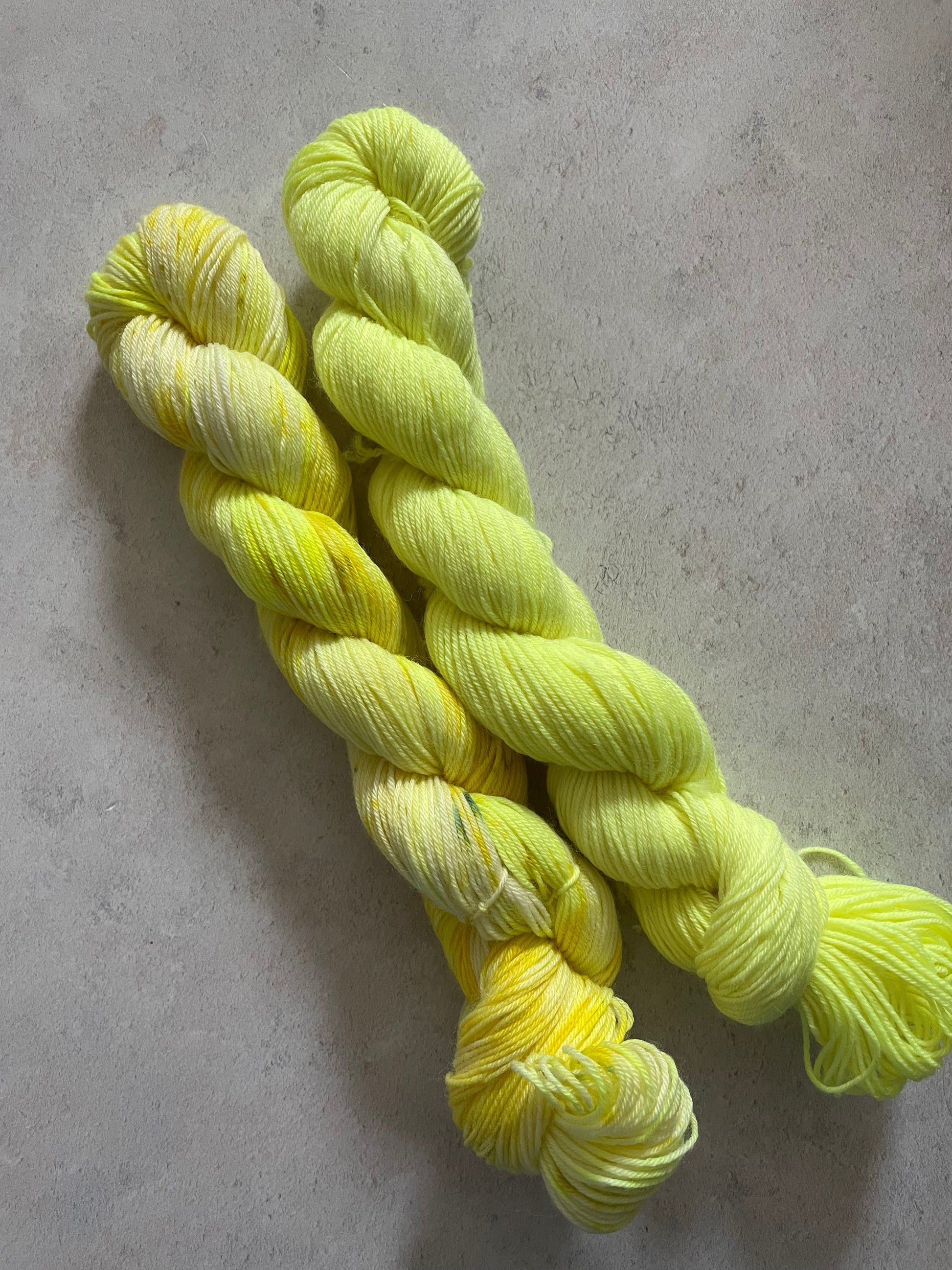 One 50g variegated bright yellow skein and one 50g bright yellow skein