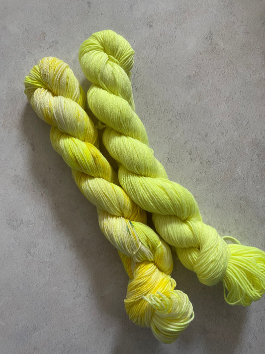 One 50g variegated bright yellow skein and one 50g bright yellow skein