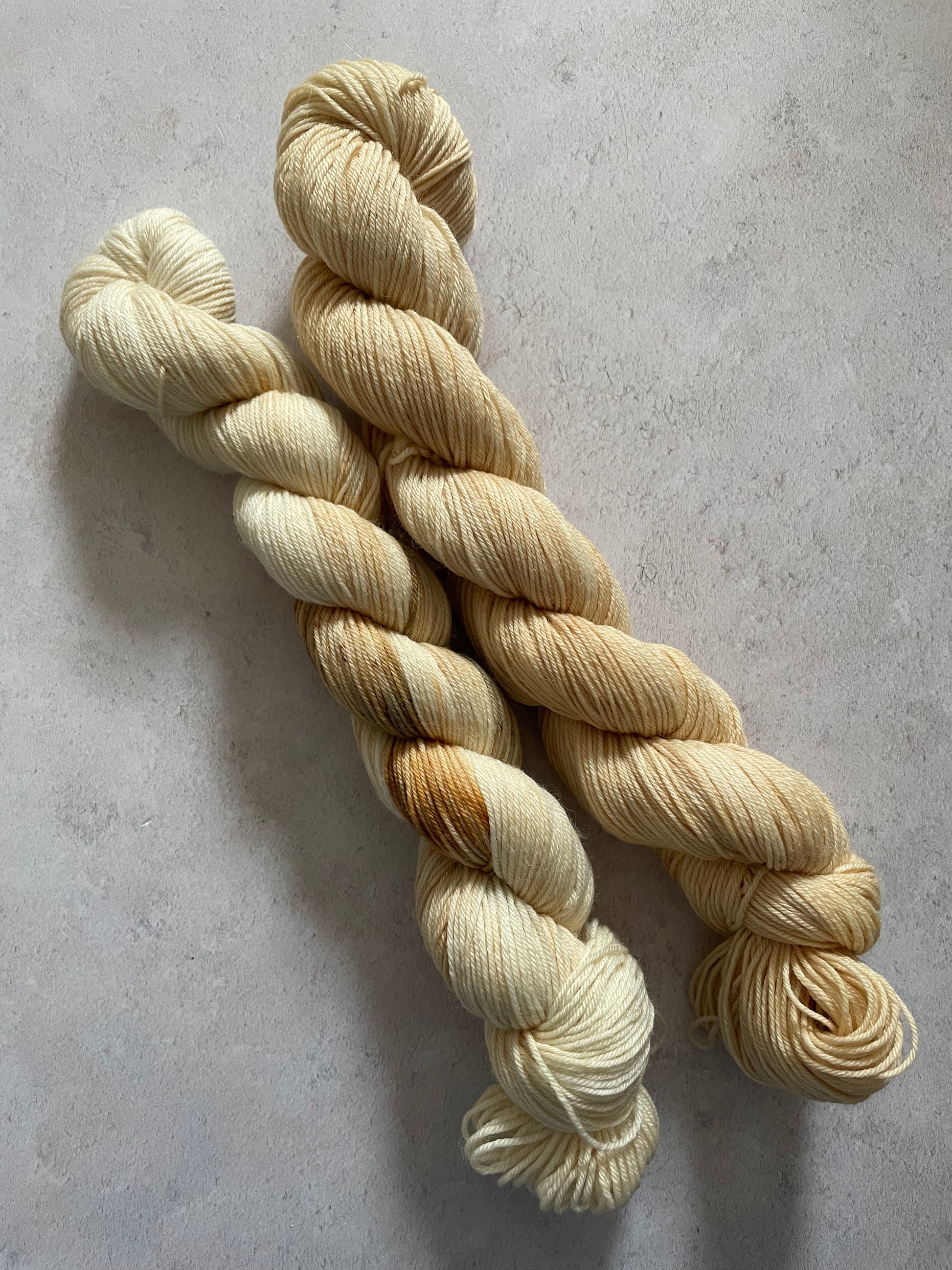 One 50g variegated cream and brown skein and one light brown skein