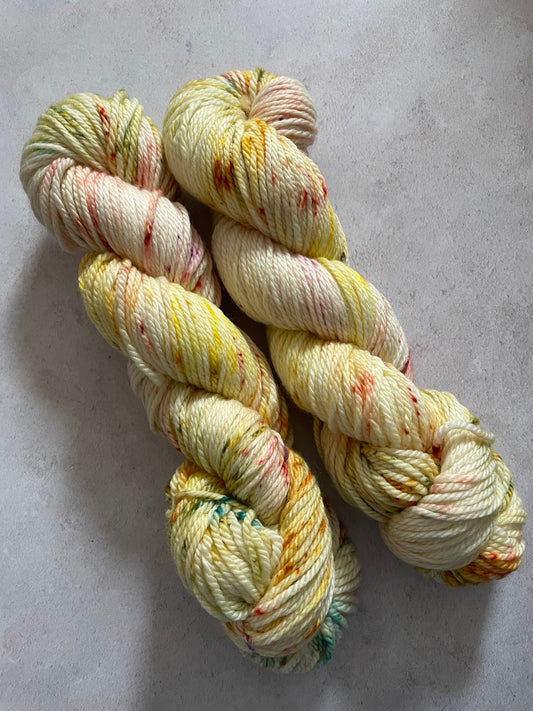 Yellow Aran yarn with red and green speckles