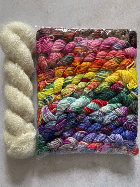 Skein of cream fluff yarn and 12 10g double knitting weight minis