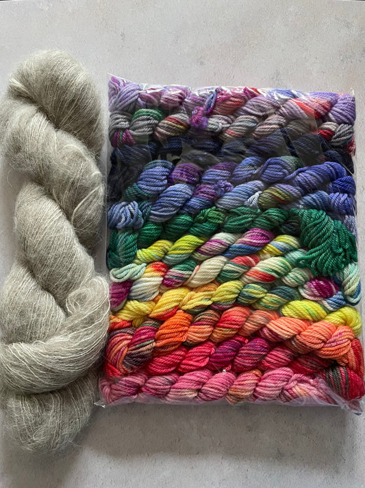 Skein of grey fluff yarn and 12 10g double knitting weight minis