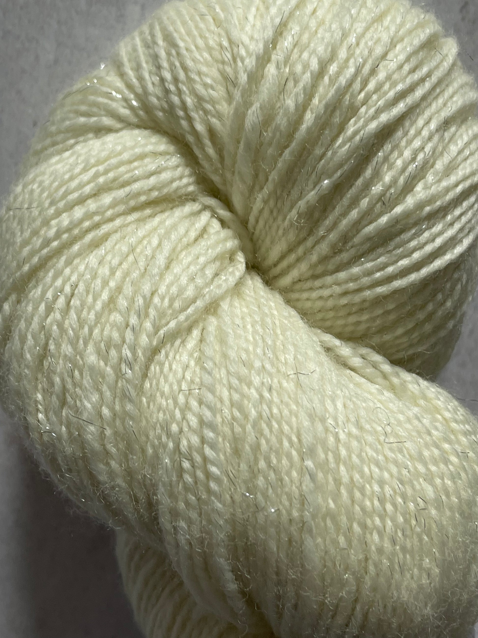 A close up of undyed silver sparkle sock