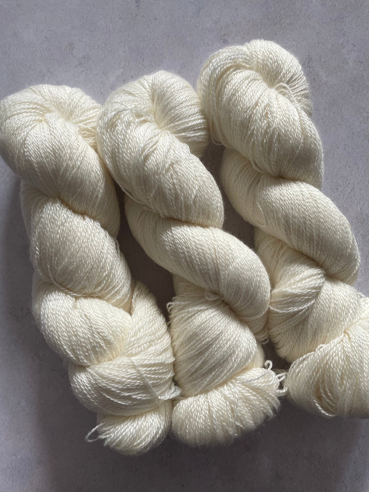 Three skeins of merino and silk lace yarn