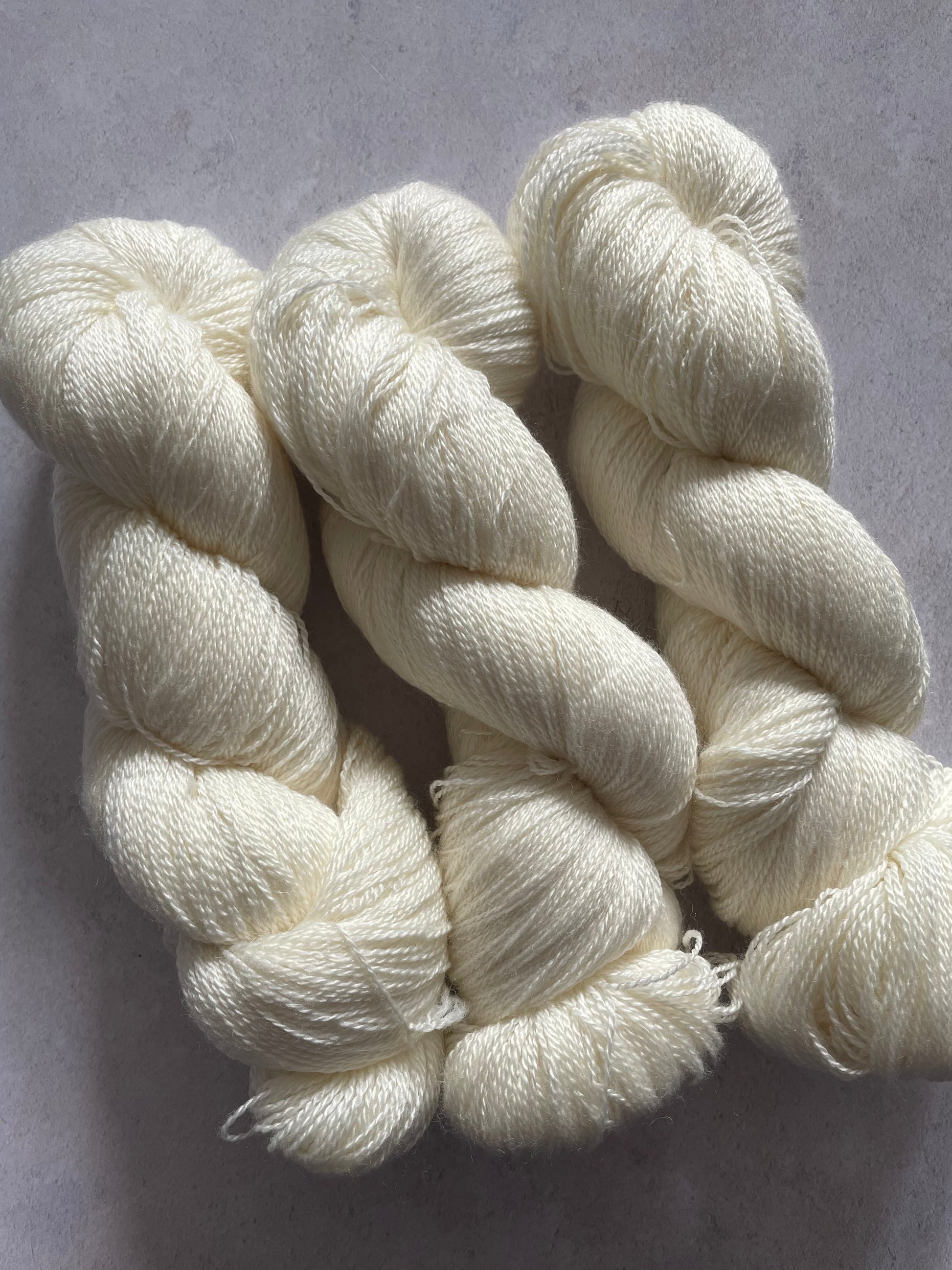 Three skeins of merino and silk lace yarn